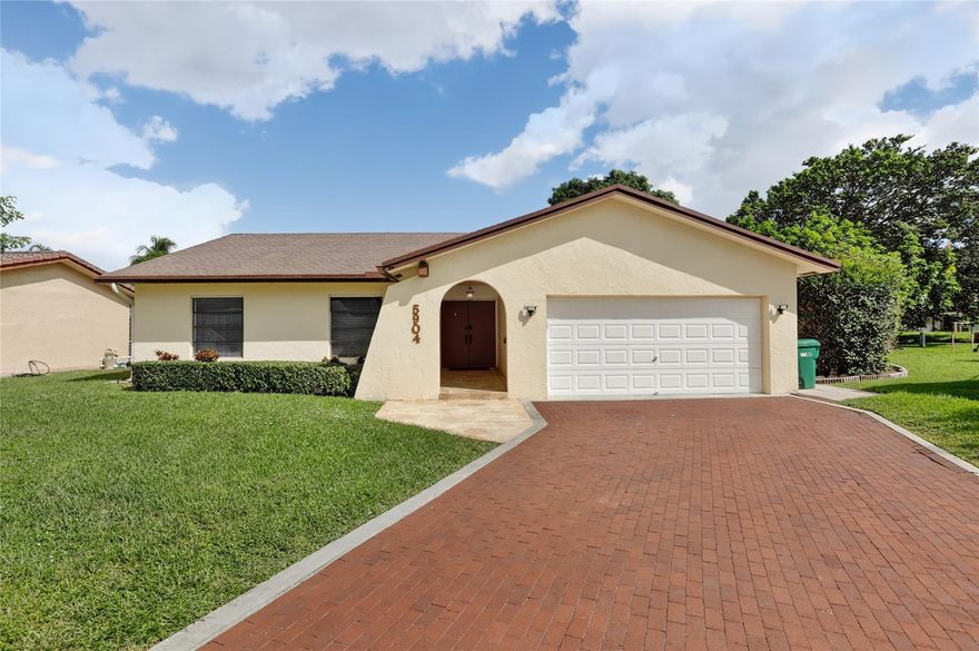 Welcome to this thoughtfully renovated 3 bed, 2 bath retreat in the Woodlands—Tamarac’s best-kept secret. The updated kitchen blends function and charm, opening to a bright great room and dining area ideal for easy gatherings. Large sliders lead to a screened pool area perfect for year-round lounging, dining, or a morning swim. The primary suite is designed for both calm and versatility, with a refreshed en suite featuring dual sinks and a walk-in shower with timeless subway tile. Two generously sized bedrooms surprise and delight with flexibility for sleep, work, or play. Vaulted ceilings, new flooring, fresh paint, and abundant natural light complete the home’s easygoing, elevated vibe.