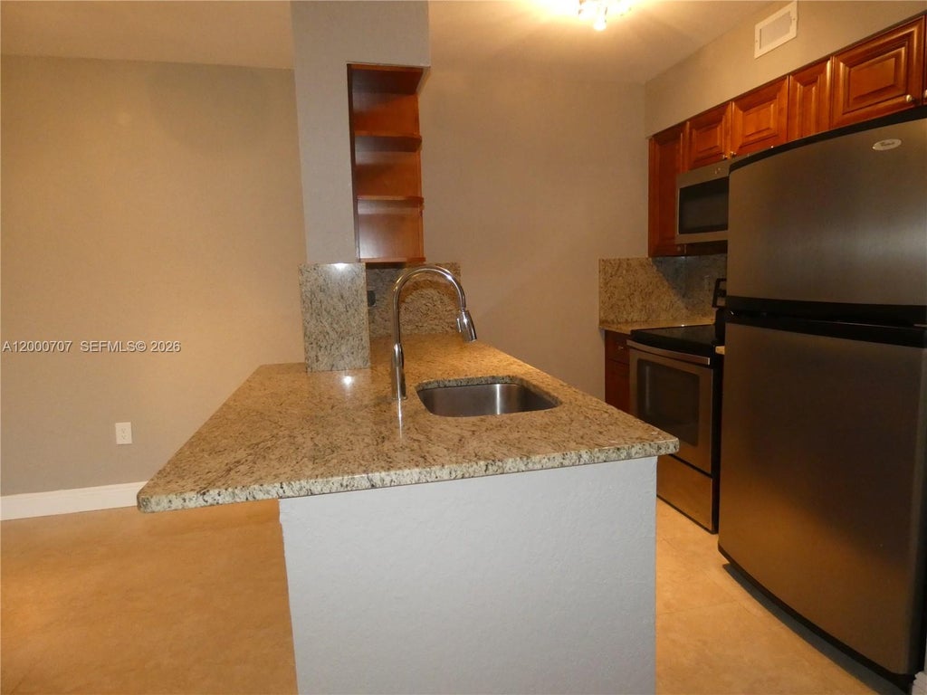 Photo of 2841 N Oakland Forest Drive #207, Oakland Park, FL 33309 (MLS # A12000707)