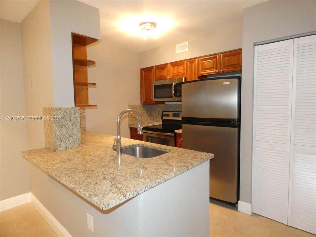 Photo of 2841 N Oakland Forest Drive #207, Oakland Park, FL 33309 (MLS # A12000707)
