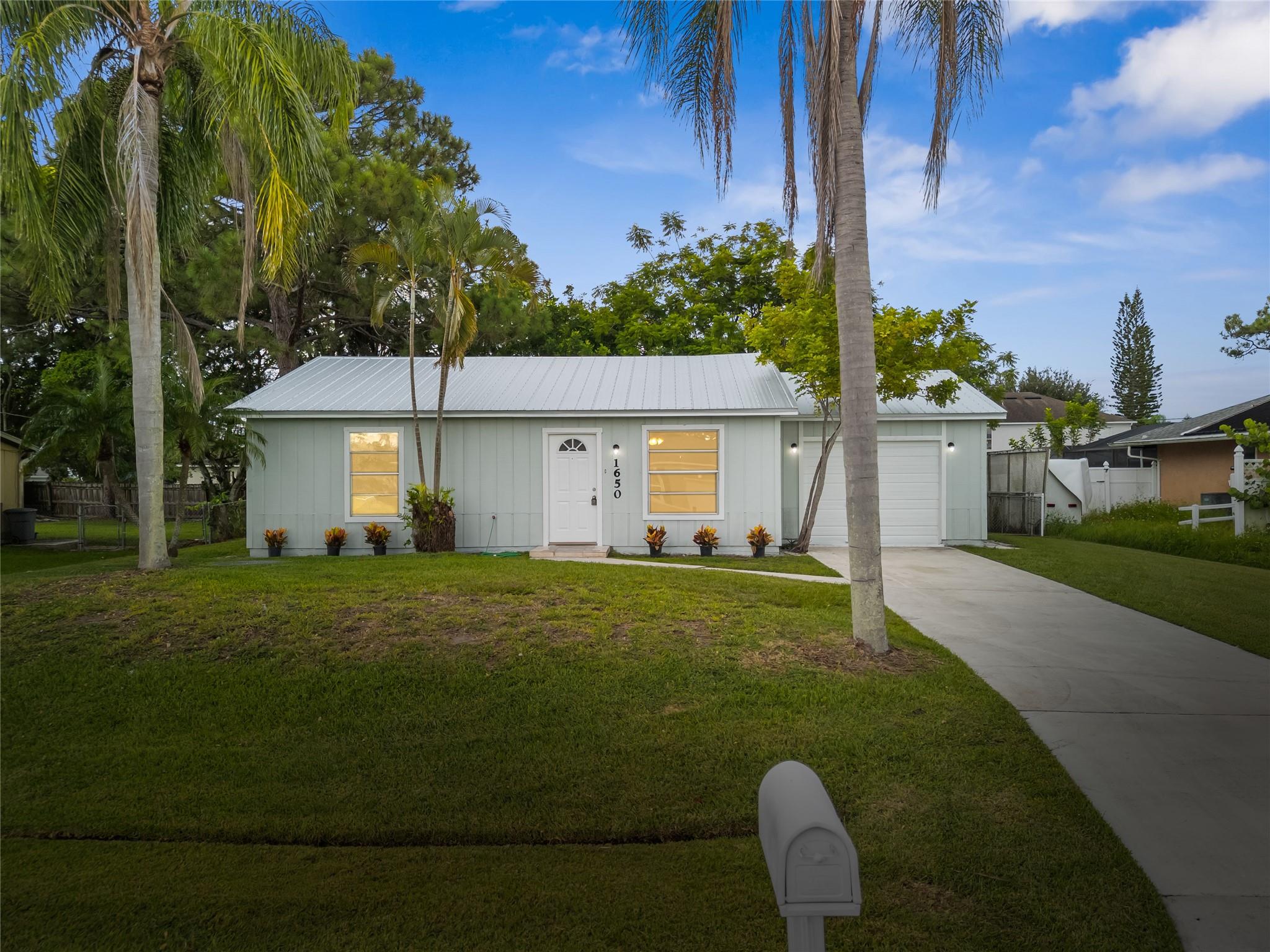 Step into this renovated beauty—fully upgraded in 2025! Featuring a new metal roof, new A/C and ducts, new kitchen and baths, new flooring, partial new side panels, and fresh paint! The heart of the home is the kitchen and dining room, perfect for family meals and gatherings, with French doors opening to a screened patio and huge fenced backyard. Imagine backyard barbecues, kids playing under the shaded trees, or pets running free. The partially converted garage offers a versatile 3rd bedroom, office, or hobby space with room for storage. The home has ample sunlight and fresh feel. Includes a 2025 mold certification for peace of mind! Located outside the flood zone, minutes from I-75, the FL Turnpike, boardwalks, beaches, golf, baseball, and dining!