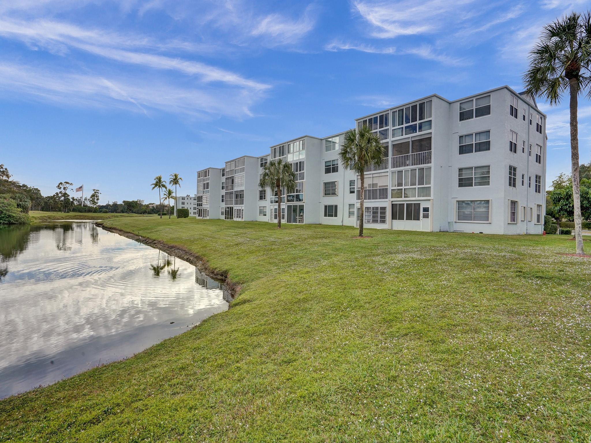 SELLER WILL PAY ASSESSMENT IN FULL!! Waterfront Golf Course Living!! With This Open & Airy Corner Unit With Stunning Views! Nestled In A Prime Location, This 2/2 Offers A Perfect Blend Of Sophistication & Scenic Beauty. New Porcelain Tile & Panoramic Views Of The Lush Greenery Of The Golf Course & Serene Waterside Landscape. The Spacious Living Area Is Bathed In Natural Light Starting Your Day W/ Sunrise Views. New Appliances, LED High Hats & Ample Storage In Large Kitchen Complete W/ Washer & Dryer. The Primary Suite Is A Retreat In Itself, Offering More Stunning Views W/ Extra-Large Windows, Walk-In Closet, & Brand New Spa-Like Ensuite Bath. The 2nd Bedroom Is Equally Well-Appointed, W/ Bonus Window. Water Heater '17. 55+ 675 Credit 32K POI & 3 Mths Dues In Escrow 20% down req'd