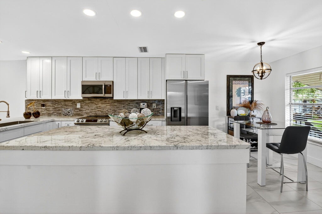 Photo of 13213 LUCINDA PALM Court #D, Delray Beach, FL 33484 (MLS # B26089700)