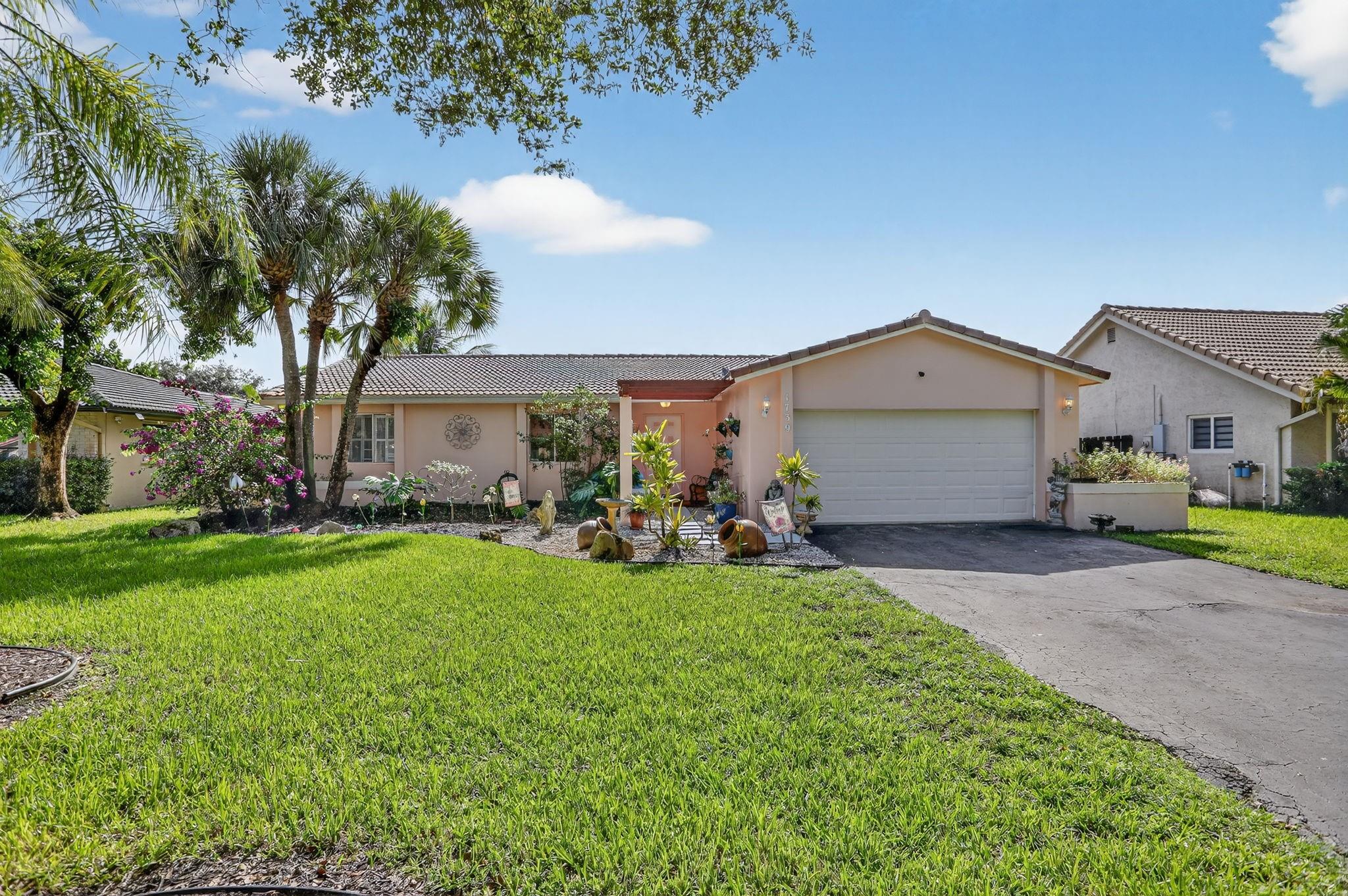 Brand NEW ROOF Being Installed! Bright & spacious 3BR/2BA/2CG single-family home in the heart of Coral Springs with NO HOA fees! This well-maintained home offers an open floor plan and a lushly landscaped private fenced yard with both screened & open patio areas —perfect for relaxing or entertaining. Neutral paint and freshly cleaned & stained tile floors.  The updated kitchen features granite countertops and stainless-steel appliances (all less than 5 years old). Bathrooms have been tastefully remodeled, and the home includes updated electrical, 2020 A/C, 2020 water heater, 2025 duct cleaning, and an impact-rated garage door. Enjoy the extra-long driveway, plenty of natural light, and a well for the sprinkler system. Centrally located near top-rated schools, parks, dining, and shopping.