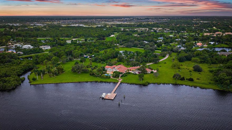 Epic Riverfront | Palm City, Florida.A rare, once-in-a-generation opportunity to own a true slice of Old Florida , nearly 18 acres of pristine riverfront property with 832 linear feet of waterfront on the wide waters of the St. Lucie River.From the moment the gates open and you drive up the epic driveway framed by native palms, this property will take your breath away. The main residence spans approximately 9,150 square feet, featuring 7 bedrooms and 7.1 baths, a resort-style pool, and expansive open living spaces designed for grand entertaining and effortless indoor/outdoor living, the ultimate Florida lifestyle.The estate also includes a detached, state-of-the-art gym and a spacious Guest House / Staff Quarters, offering privacy and comfort for family,  guests, or full-time