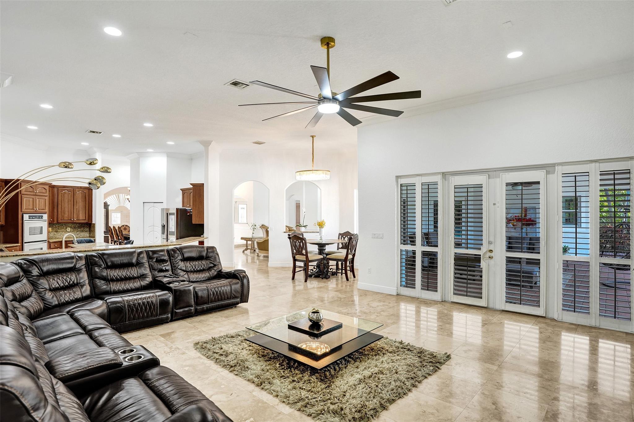Welcome to this stunning 5-bedroom + office, 6,000+ sq. ft. estate in the prestigious Plantation Acres community. Designed for those who appreciate luxury and space, this home boasts soaring volume ceilings and elegant marble flooring, creating an ambiance of grandeur. The expansive master suite features a private sitting room, offering the perfect retreat for relaxation. The living and dining areas flow seamlessly outside to your private outdoor oasis, where a huge covered patio and summer kitchen set the stage for unforgettable gatherings. Lounge by the sparkling pool or enjoy the expansive private backyard. Experience the best of Plantation Acres living. Don’t miss this rare opportunity to own a home of this caliber!