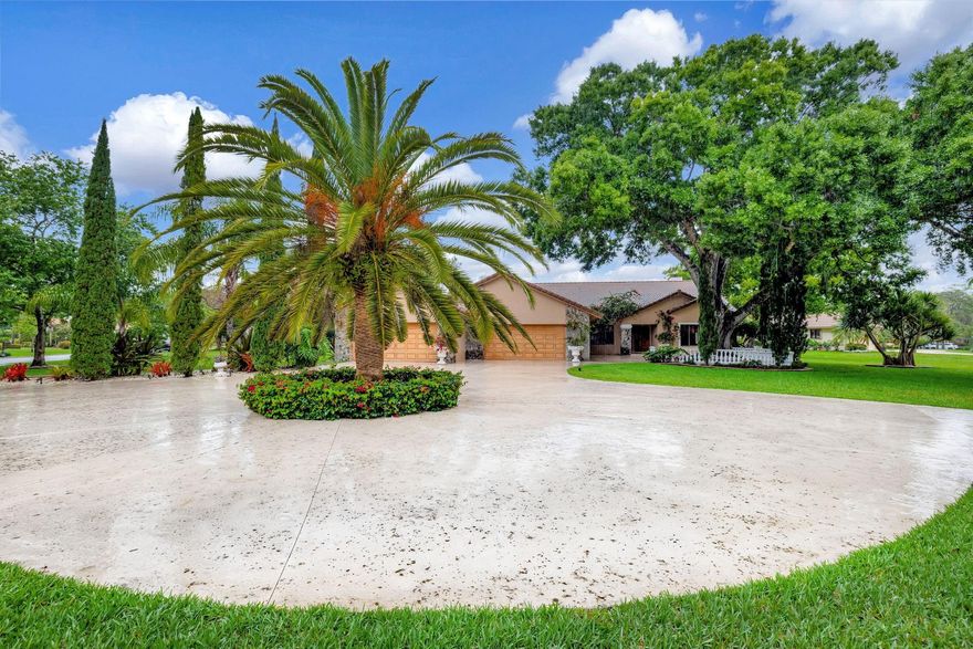 WOW, 6 AIR CONDITIONED GARAGES! SET ON OVER AN ACRE CORNER LOT, THAT PROVIDES LOTS OF ROOM FOR MULTI-GENERATIONAL EXPANSION. , HUGE CONCRETE CIRCULAR DRIVE, LOVELY MATURE LANDSCAPING & OUTDOOR LIGHTING. CUSTOM ELEGANCE, FEATURES BEAUTIFUL STONE FLOORS,  WOOD BURNING FIREPLACES, ONE IN THE FAMILY ROOM & ONE IN THE PRIMARY SUITE.  WHITE KITCHEN WITH GRANITE COUNTERS, 3 A/C SYSTEMS, WHOLE HOUSE CENTRAL VAC, VOLUME SMOOTH CEILINGS. SCREENED IN POOL/PATIO, WITH OVERSIZED DECK & PERFECT FOR ENTERNTAING PATIO KITCHEN INCLUDES, BBQ, ELECTRIC OVEN, REFRIG, & SINK. WHISPERING WOODS IS A GUARD GATED COMMUNITY WITH ESTATE SIZE HOMESITES AND FABULOUS MATURE LANDSCAPE. COME MAKE THIS SPECIAL HOME & PROPERTY YOUR VERY OWN.