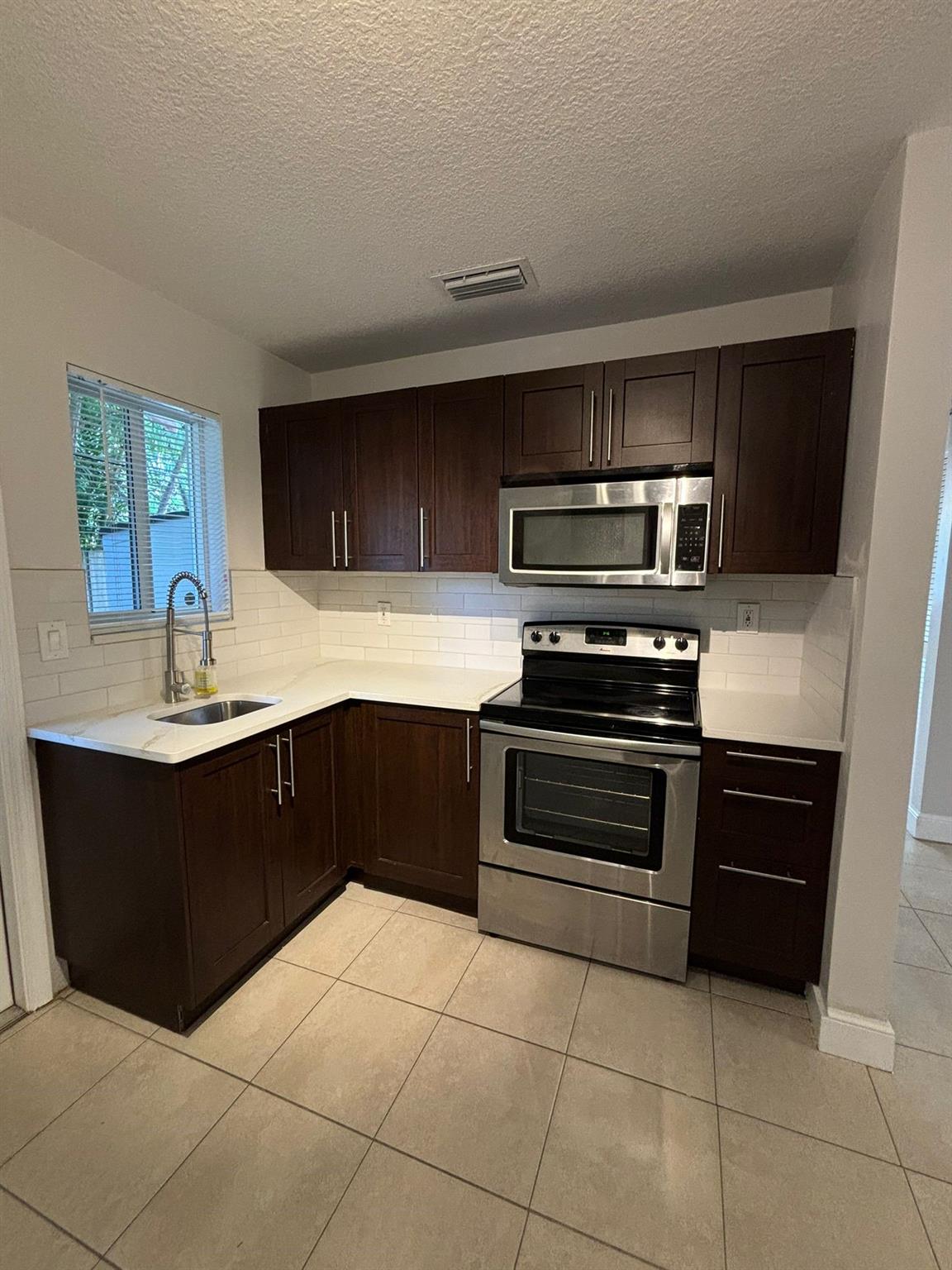 Welcome to your new home! Spacious and remodeled 2 bedroom/2 bathroom apartment in the heart of Fort Lauderdale offers a perfect blend of modern amenities and stylish finishes with it's own back yard!. Ideal for those seeking comfort and convenience, this apartment is ready for immediate move-in. Nestled in a vibrant neighborhood, you'll be close to shopping centers, restaurants, parks, and public transportation. Spacious and open floor plan with abundant natural light, fully updated kitchen with stainless steel appliances, quartz countertops, custom cabinetry, perfect for culinary enthusiasts. Generously sized bedrooms, closet space and large windows, providing a serene and comfortable retreat. Modern and sleek bathrooms with high-end fixtures and tiled showers. Washer and Dryer in unit.