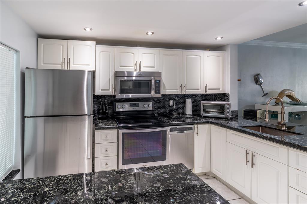 Live the island lifestyle in this comfortable, beautifully decorated 1-bedroom a bath and covered patio condo at Paradise Island featuring stunning canal views, a remodeled kitchen with granite countertops and stainless-steel appliances, a screened patio, parking right outside the door, and a prime location just minutes from Hallandale Blvd shops and the beach—also available for 4-month rentals, different rates apply.