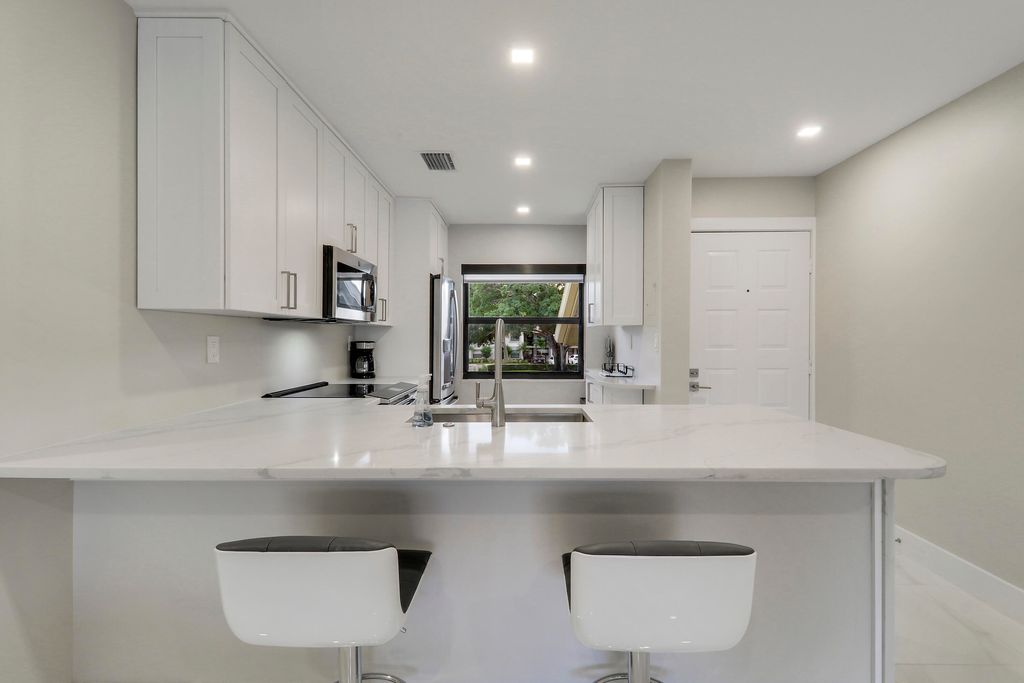 Photo of 12911 Briarlake Dr #202, Palm Beach Gardens, FL 33418 (MLS # B26000636)