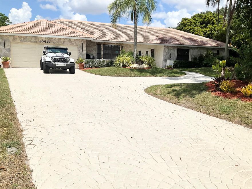 One of the largest homes in Coral Springs at just under 4000 sq ft, on nearly a half acre of land.
Exquisite 4 bedroom, 4 bathroom estate with sweeping driveway, sprawling lot & lush landscaping on peaceful cul-de-sac in the desirable neighborhood of 'The Oaks'. NO HOA.
This beautifully kept home features two spacious master suites, huge walk in closets, a cedar closet, new roof 2025, newer a/c's, new tile & a  gourmet kitchen with custom cabinetry, stainless appliances & waterfall granite countertops. The resort style backyard boasts an oversized diving pool, fountain, gazebo, large garden with deck and gorgeous sunset views. The outside bar and grill area features an open seating area to enjoy the lovely Florida evenings.