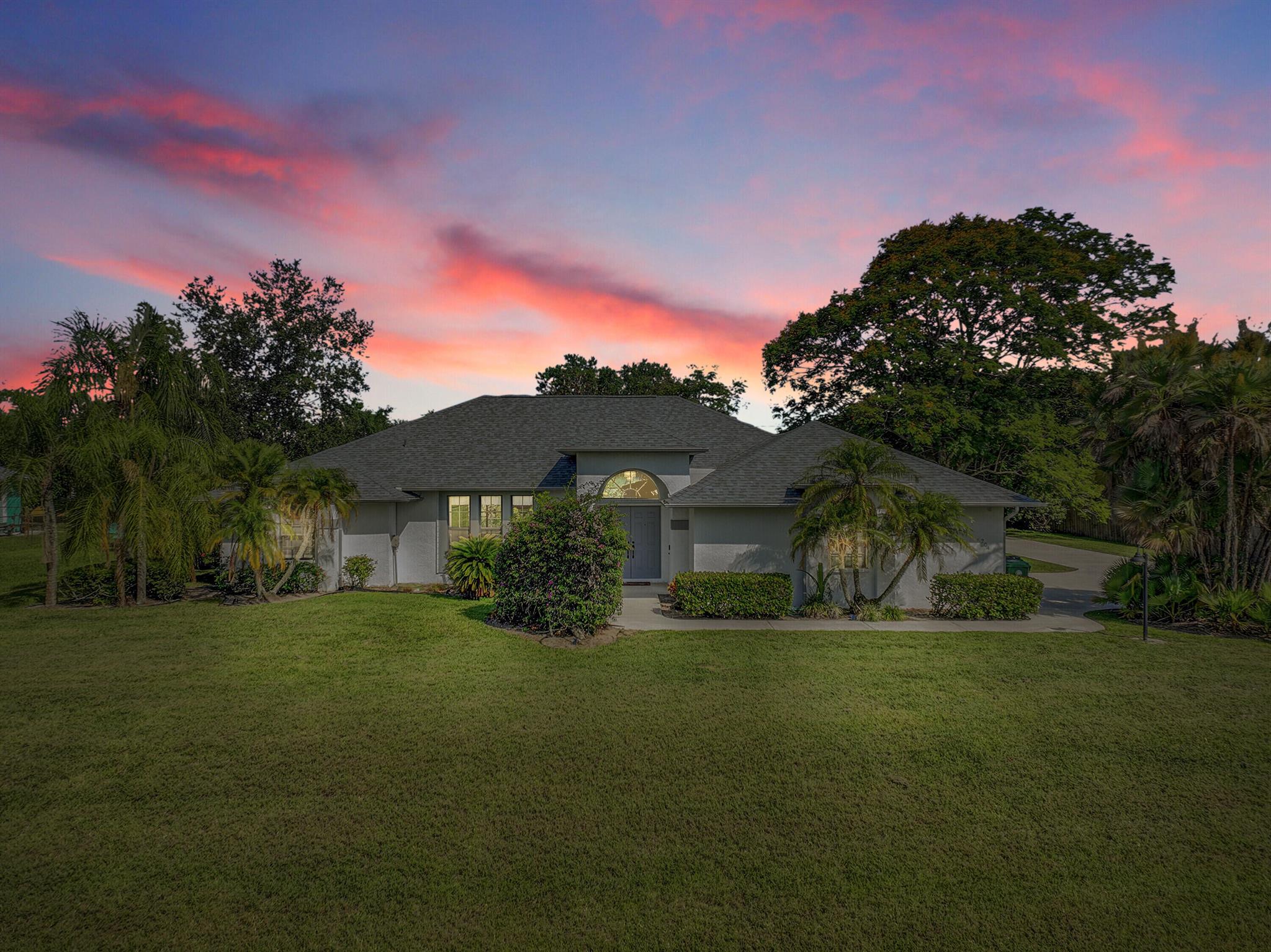 Set on nearly half an acre in desirable Paar Estates, this 3-bedroom, 2.5-bath CBS pool home offers a thoughtful blend of space, updates, and outdoor living. A brand new roof and recent connection to city sewer provide peace of mind, while the kitchen features granite countertops and new stainless steel appliances. The layout includes cathedral ceilings, defined living and dining areas, and a primary suite with two walk-in closets, a roman tub, and separate shower. Step outside to a screened patio and sparkling pool perfect for relaxing or entertaining. Additional highlights include a cabana bath, inside laundry room, underground utilities. Added RV Pad for recreational vehicles. A well-maintained property in a desirable location with features that support a Florida lifestyle.