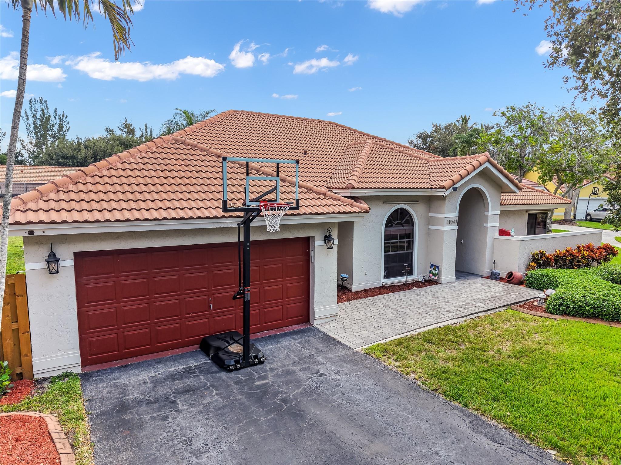 Welcome to one of the most desirable streets in Fox Run! This upgraded 4-bed, 2.5-bath home sits on a private 12,504 sq ft lot at the end of a quiet cul-de-sac. Enjoy soaring ceilings, a tray-ceiling main suite, & ceramic tile throughout. The 2019 kitchen/baths were tastefully renovated w/quartz counters, Samsung appliances, & soft-close cabinetry. Custom California Closets added in 2022. In 2024, the garage was outfitted w/split AC, epoxy floors, home gym (folds up to park 2 cars), & overhead storage. Screened patio opens to a 2,000 sq. ft. pool deck- perfect for entertaining. New fence & front gates, generator-ready, & smart security. Minutes from highways, Sawgrass Mills Mall, Amerant Bank Arena, Plantation Central Park, Walking distance - Volunteer Park. SEE FULL UPGRADE SHEET ATTACHED