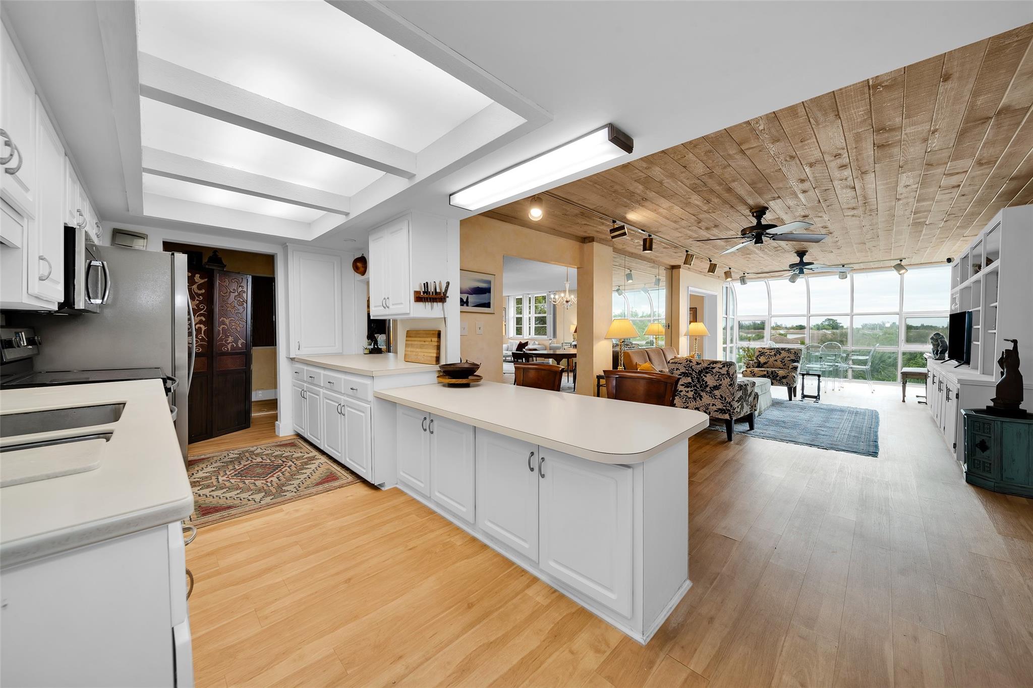 RENT RIGHT AWAY in this ALL AGE community of Villa Lago. This large 3/2 corner unit condo features: Partial impact windows, updated kitchen w/white cabinetry, SS appliances, breakfast bar, and stylish built-ins with plenty of storage. Luxury vinyl flooring throughout the main living areas and shiplap ceilings make you feel right at home. The formal dining area is perfect for entertaining while the plantation shutters adorn the windows. The primary suite has a spacious walk-in closet while natural light floods throughout. This unit comes with 2 ASSIGNED PARKING SPOTS & a WASHER and DRYER in the unit which is very rare! while amenities include a community laundry room, pool, extra storage locker on the same floor, and close to shopping, dining, major highways and the beach! DON'T WALK, RUN!