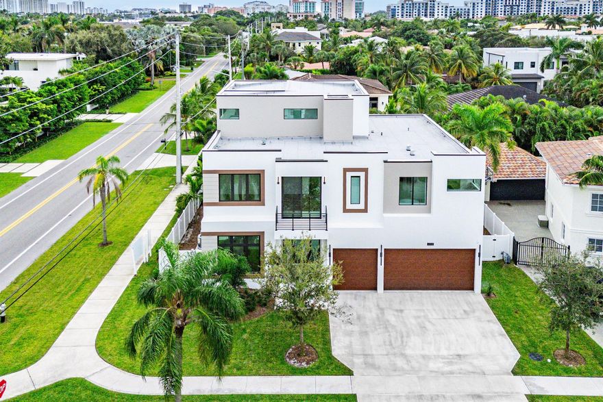 New Construction Completed and Ready for Occupancy! Redefining modern luxury in East Boca's coveted Golden Triangle, this 5BD/6.5BA residence is set on a premium corner lot just steps from the beach, Mizner Park, Royal Palm Place, The Boca Raton Club, and downtown shopping and dining. Thoughtfully designed for comfort and entertaining, the home features 11-ft ceilings, a sunlit open-concept great room, dining area, and chef's kitchen with waterfall quartz island, Wolf gas range, SubZero fridge, 2 Cove dishwashers, and walk-in pantry. Porcelain tile floors, glass-paneled staircase, and a club room with wet bar complete the 1st level. Covered patio and pool deck include a built in grill and a heated Diamond Brite pool with spa. Upstairs: 9-ft ceilings, oak floors, 3 en-suite bedrooms plus
