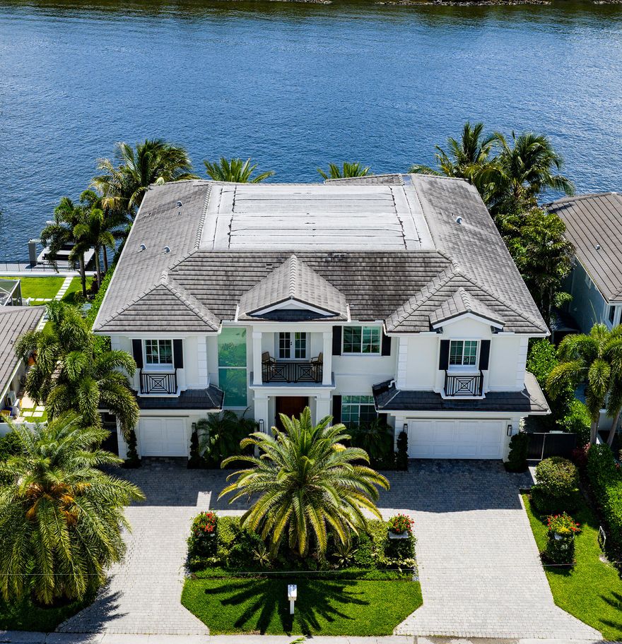 Beautiful landscaping sets the tone for this magnificent waterfront estate in Boca Harbour Island, imparting a luxuriant sense of place, while the rear gardens offer resort-style outdoor living. The loggia with a summer kitchen flows out to the ice-white marble patio and the sparkling 40-foot pool with a spa and waterfall feature, where afternoons slip into languid leisure. A boating-enthusiast's dream, this luxury residence fronts 85 feet on a wide stretch of the Intracoastal Waterway, and a 40-foot pier dock extends from the private 60-foot concrete dock, complete with a 15,000-pound hydraulic boat lift and a 5,000-pound Jet Ski lift. DISCLAIMER: Information published or otherwise provided by the listing company and its representatives including but not limited to prices, measurements, square footages, lot sizes, calculations, statistics, and videos are deemed reliable but are not guaranteed and are subject to errors, omissions or changes without notice. All such information should be independently verified by any prospective purchaser or seller. Parties should perform their own due diligence to verify such information prior to a sale or listing. Listing company expressly disclaims any warranty or representation regarding such information. Prices published are either list price, sold price, and/or last asking price. The listing company participates in the Multiple Listing Service and IDX. The properties published as listed and sold are not necessarily exclusive to listing company and may be listed or have sold with other members of the Multiple Listing Service. Transactions where listing company represented both buyers and sellers are calculated as two sales. "No payments made until title passes" Some affiliations may not be applicable to certain geographic areas. If your property is currently listed with another broker, please disregard any solicitation for services. Information published or otherwise provided by seller, listing company or its representatives is deemed reliable but are not guaranteed and subject to errors, omissions, or changes without notice. Copyright 2025 by the listing company. All Rights Reserved.