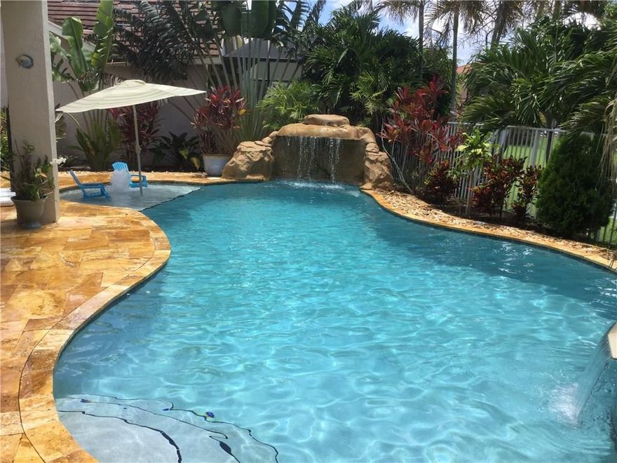 PRICED TO SELL in sought after Boca Chase! This  4 BR 3.1 bath spacious & meticulously maintained lakefront home has a 3 yr new resort style pool with spa, rock waterfall, bubbler and travertine deck. Screened master balcony overlooking lake and backyard paradise. Large master suite with his/her private baths & huge closets. New porcelain wood look tile thruout 1st floor. Stainless steel appliances. 2801 sq ft . Excellent school district.  Community rec with pools, tennis courts, basketball, tot lot.