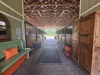 Lovely private farm with 6 stall center isle, tack room, indoor tack up, paddocks and private entrance. Very functional set up that's the ultimate style for a boutique operation. Great breeze through the isle and lovely quiet street. Great to hack out on and trail ride with accessible trailer parking.