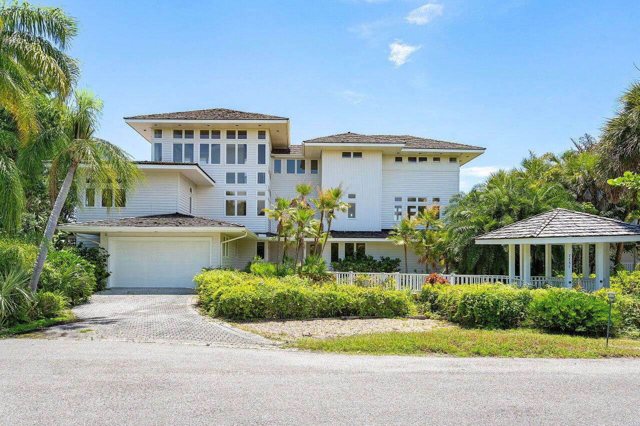 Welcome to an extraordinary opportunity in the prestigious community of Loblolly Bay, Hobe Sound, FL. This home is a magnificent masterpiece nestled on the Marina side of this private club which embodies the epitome of luxury living, offering an exceptional blend of golf and boating lifestyle.Prepare to be captivated by the casual architectural styling and breathtaking views of nature that greet you from every corner of this tri-level home. Recently updated, this residence boasts an abundance of casement windows, flooding each room with an incredible amount of natural light throughout the day. Step onto the numerous decks, some screened and some open, to immerse yourself in the mesmerizing vistas and gentle ocean breezes. The outdoor spaces are designed to maximize the enjoyment of the