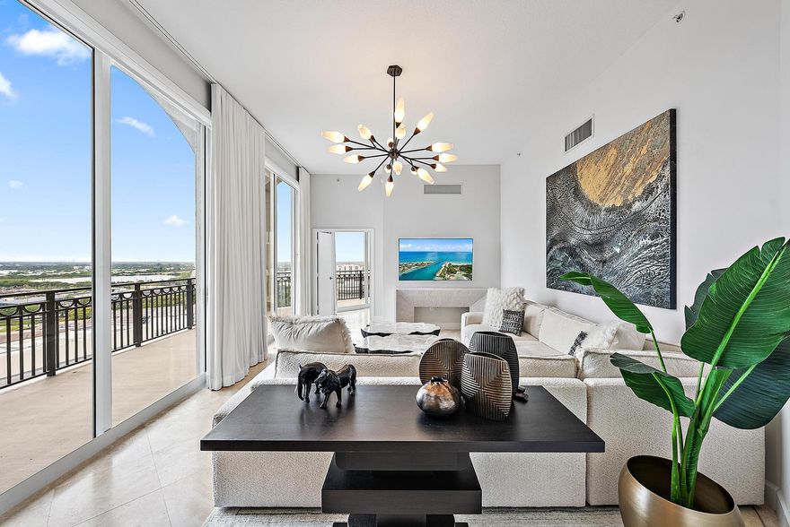 Experience elevated living in this one-of-a-kind Upper Penthouse at CityPlace South Tower. Soaring above Downtown West Palm Beach, this residence showcases sweeping panoramic city views through more than 33 floor-to-ceiling windows and soaring 11' ceilings.The chef-inspired kitchen features custom cabinetry, quartz countertops, and high-end finishes designed for both cooking and entertaining. Designer lighting, remote/Alexa-controlled motorized shades, and meticulous upgrades throughout create a refined yet comfortable atmosphere. A versatile third bedroom with a brand-new Murphy bed easily converts into a stylish guest suite or private office.