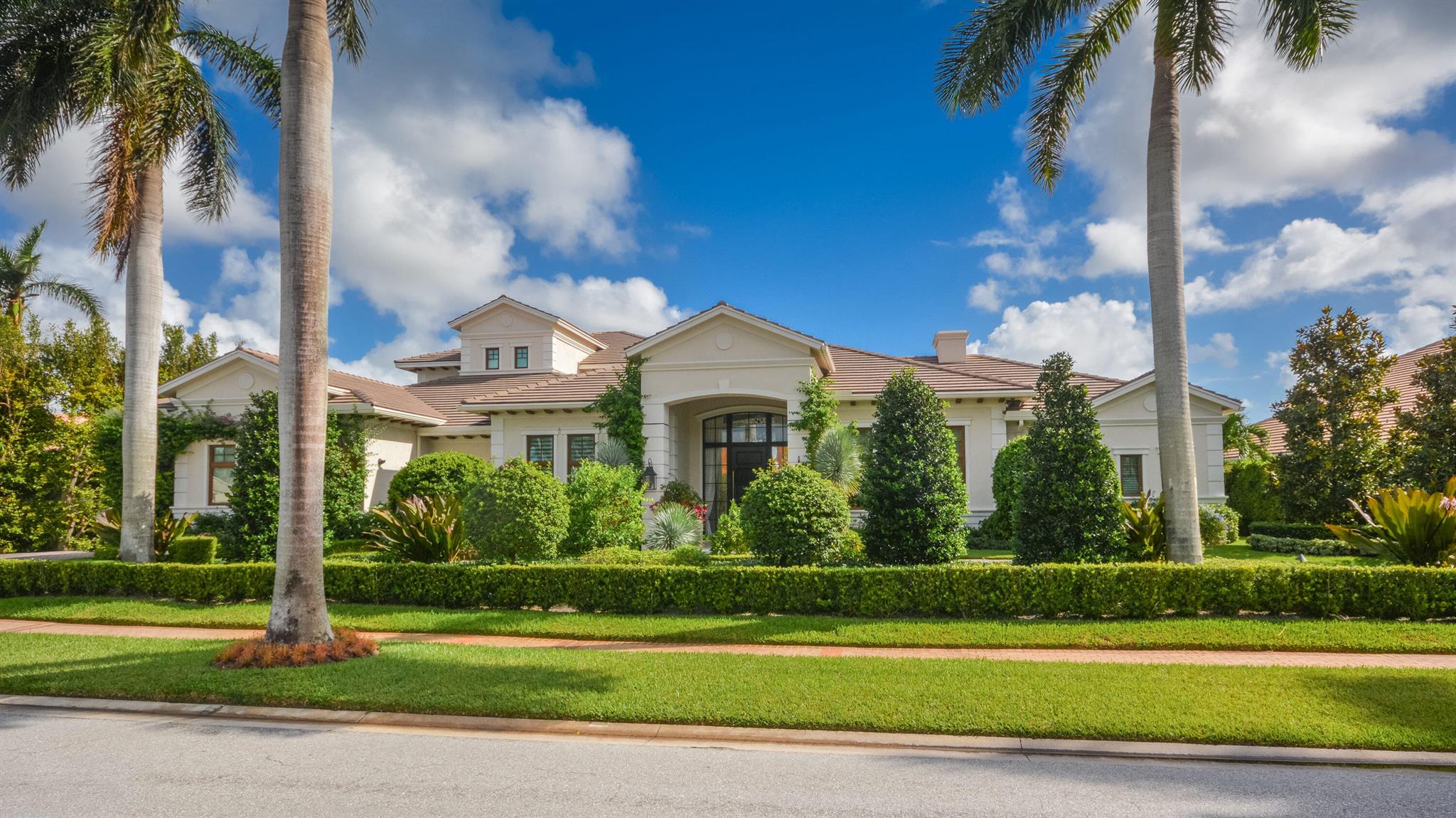 This stunning, transitional estate creates a luxurious resort-like dream on an oversized half acre lot with golf course views as a backdrop to the spectacular outdoor entertainment space on a tumbled marble terrace featuring a glass-tiled waterfall pool with LED night lighting. Featuring 5 en suite bedrooms, 6 1/2 bathrooms, office and upstairs family room, this estate is designed with casual elegance that gives the signature look of this meticulous design. Statuesque palms and flowering foliage make a beautiful impression at the entrance into the grand two-story foyer, where the view sweeps through the airy open living spaces in a layout that meets every need for today's discriminating buyer. The great room's large open gathering space centers around a showpiece kitchen designed for the