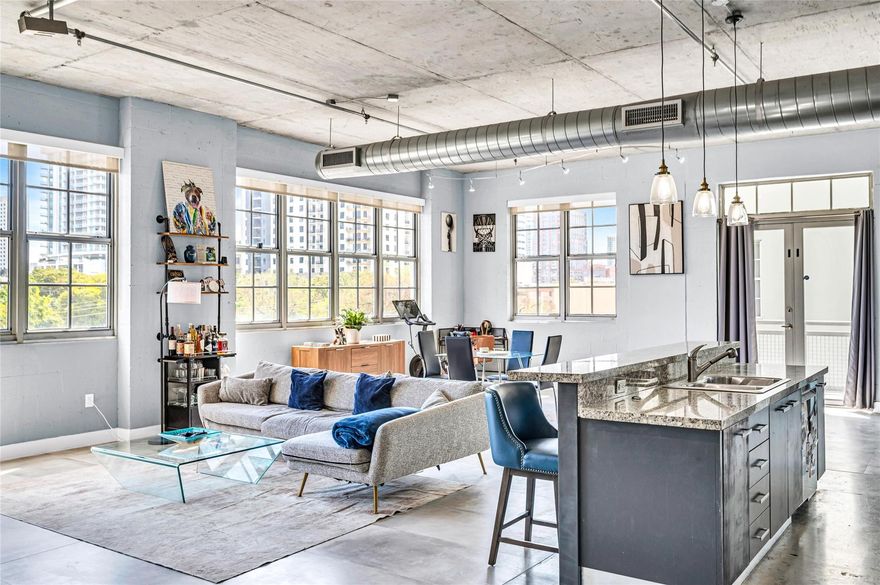 Recent updates have been made to this Urban Cool 2 Bed/2 Bath Corner Loft in Flagler Village! This light-filled corner unit features soaring ceilings, exposed ductwork and concrete block walls - a true industrial feeling. Open floor plan with walls of windows offering abundant natural light. Pet-friendly (2 pets, no weight limit).  Recent building exterior renovation/waterproofing project completed—all assessments paid.  Building is fully compliant with 2025 safety and RESERVE requirements. Renovated rooftop pool & fitness center with stunning skyline views. Prime location just 2 blocks from Brightline train, 1 block from the exciting new FAT Village development (nearing completion),   Walkable, vibrant, and connected—urban living at its best. Ok to Lease right away. Annual leases only.