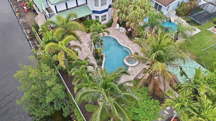 Welcome to 4412 SW 34th Ter. This custom built 3,768 sq ft, four bedroom, three bathroom, corner canal-front home is situated on a 16,709 sq ft lot with ocean access and only one fixed bridge. 100 ft dock with full concrete seawall and lowered dock section is perfect for boaters. Aluminum roof and hurricane impact windows and doors for piece of mind. Open kitchen that features a Sub Zero refrigerator, Miele espresso maker, Wolf cooktop and a reverse osmosis water system. Multi zoned air conditioning with separate thermostats for upstair and downstairs. Experience comfortability with the in-ground propane tank powering a recently upgraded whole-home generator that is plumbed into your outdoor grill. Your backyard oasis includes a heated pool, hot tub and a cabana bath for gatherings.   Downstairs features three separate rooms currently used as an office, a dedicated gym/fitness room, and a media/TV room. The media room includes a closet and offers flexibility for use as a potential fourth bedroom. Available fully furnished.