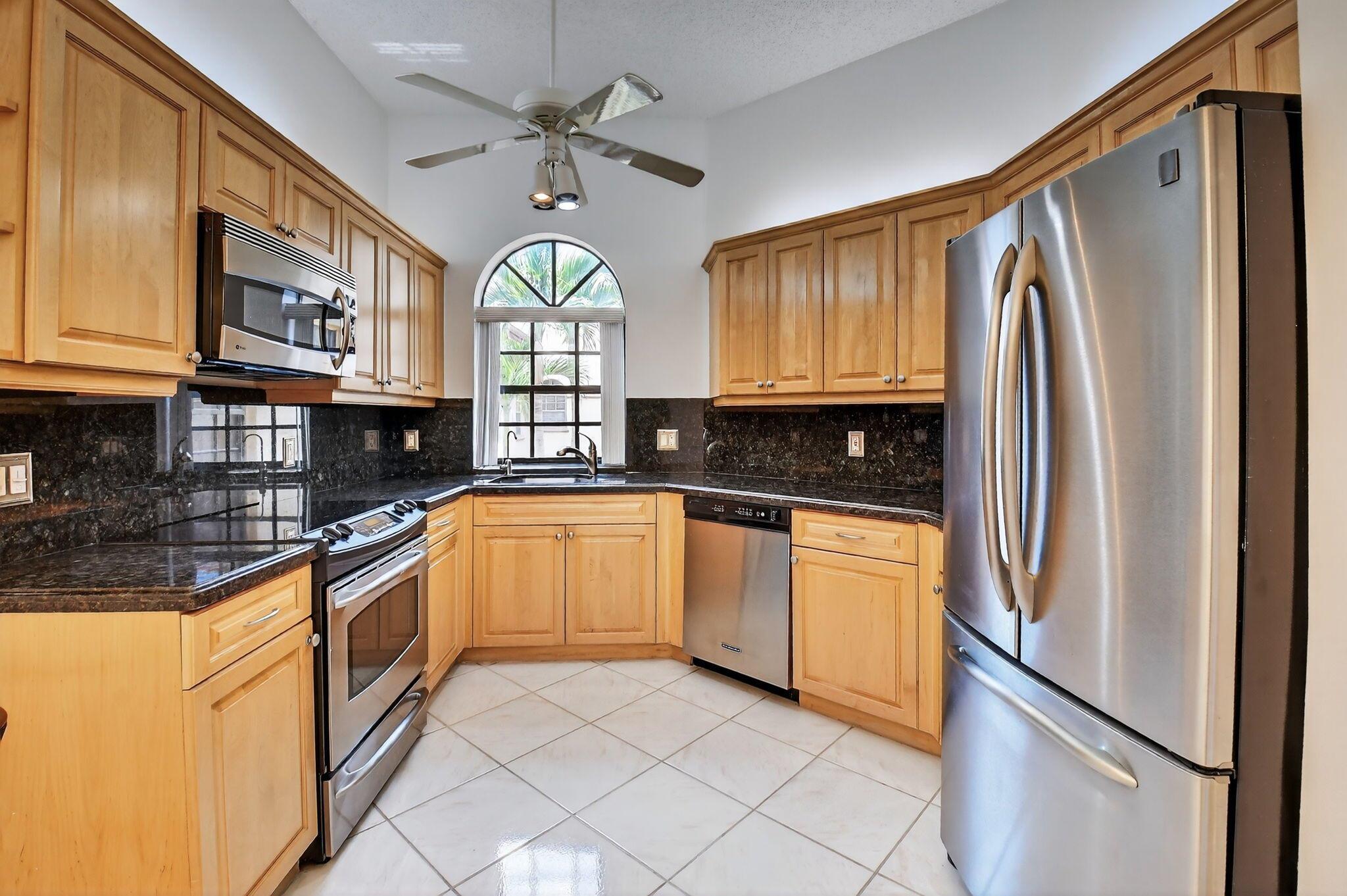 This Grandi model condo boasts its own private elevator and private staircase just inside the front door. Once upstairs, you will be greeted by a freshly painted home with soaring vaulted ceilings and a bright, open layout designed for comfortable living and entertaining. The generous floor plan offers two bedrooms plus a den that can easily be converted into a third bedroom to suit your needs. The updated, spacious kitchen is sure to inspire your inner chef. Features include granite countertops and matching backsplash, stainless-steel appliances, a double oven, a large pantry, and abundant storage space. Retreat to the master suite, which offers a large walk-in closet, linen closet and en-suite bathroom, complete with dual sinks, a vanity, a relaxing Roman tub, and walk-in shower.