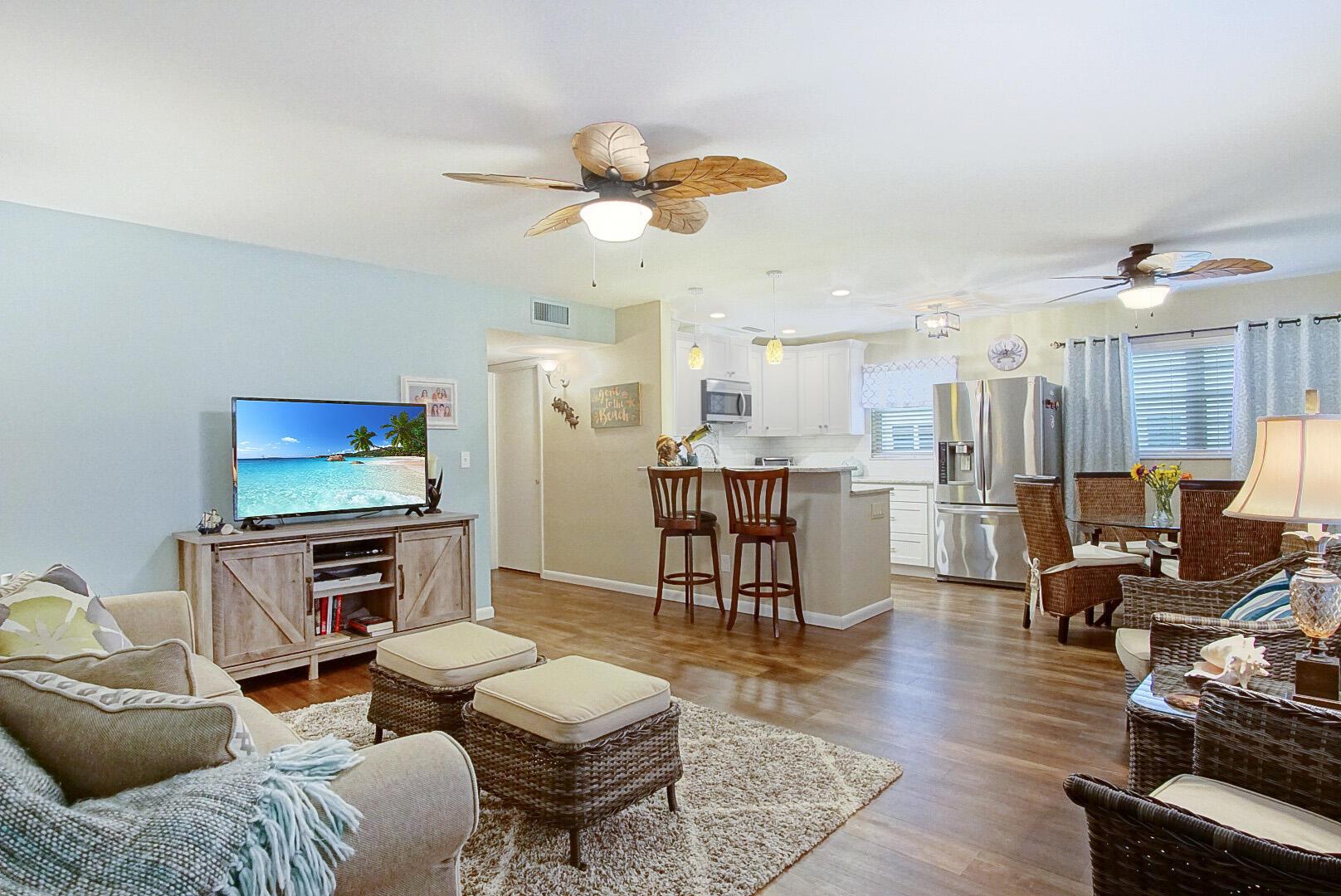 Stunning remodeled 2/2 1st floor unit. This unit features LG stainless appliances, luxury vinyl flooring, freshly painted, granite counter tops, mother of pearl back splash & subway tile back splash, brand new 2023 hot water tank, AC 2 years old, upgraded lighting, back porch enclosed with glass windows for privacy. The building has been freshly painted this year, backs to the preserve, the buildings laundry room is steps from the front door and features a new washer & dryer. Centrally located minutes to the beach, shopping & dining. This building is all ages no age restrictions.