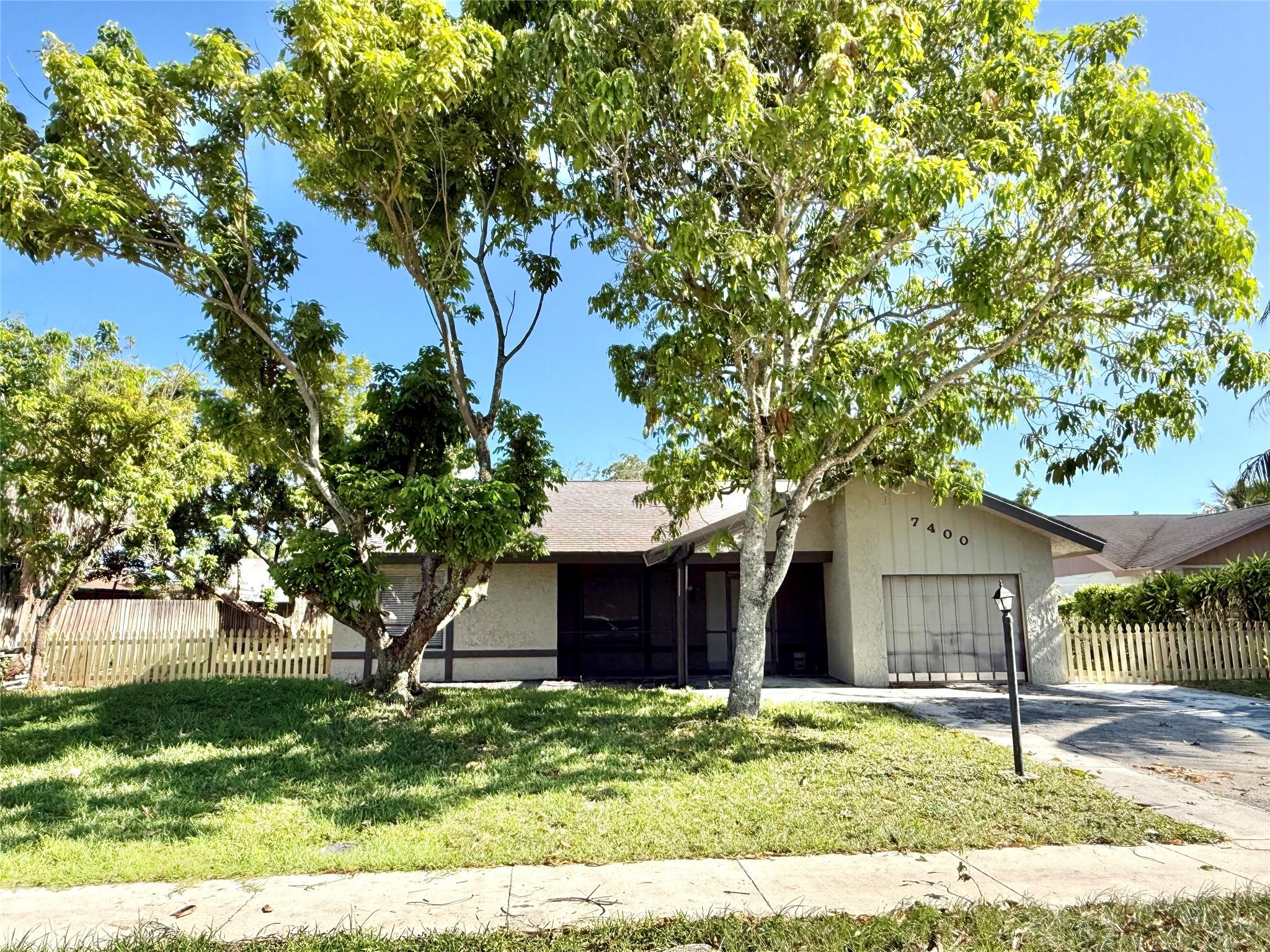 This beautifully updated 3-bedroom, 2-bathroom single-family home features a one-car garage and is ideally located in the heart of Broward County. Enjoy a fully fenced yard, a screened-in swimming pool, and a serene lake view — perfect for relaxation or entertaining. The home has been recently renovated and features modern finishes throughout, including fully tiled floors for easy maintenance. Conveniently located near major highways, shopping centers, and a variety of restaurants, this home combines comfort with accessibility. This home is move-in ready and waiting for its next family to enjoy. Rent includes lawn care and pool maintenance. Schedule a viewing today!