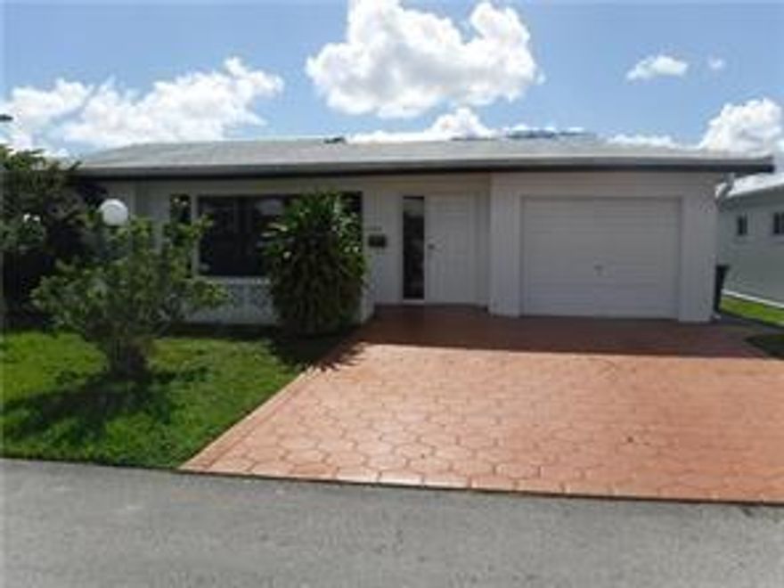 Amazing price for this spacious diamond in the rough. 2 bedrooms 2 bathrooms , one car garage and on water. Master bath is huge. Bonus room off the family room can be used as a guest room/office/den. Large screened patio overlooking the water. The home is tiled throughout, The kitchen needs 3 drawers replaced, the florida room needs the flat roof replaced some tile damage and some drywall work.  The rest of the home is clean.  We got a roof quote for 5000.00. Association maintains the lawn and sprinklers. They paint the roof every2-3 years and paint the exterior of the house every 5-6 years. Just $95.00/month! Double car driveway and nicely landscaped. 55+ community.