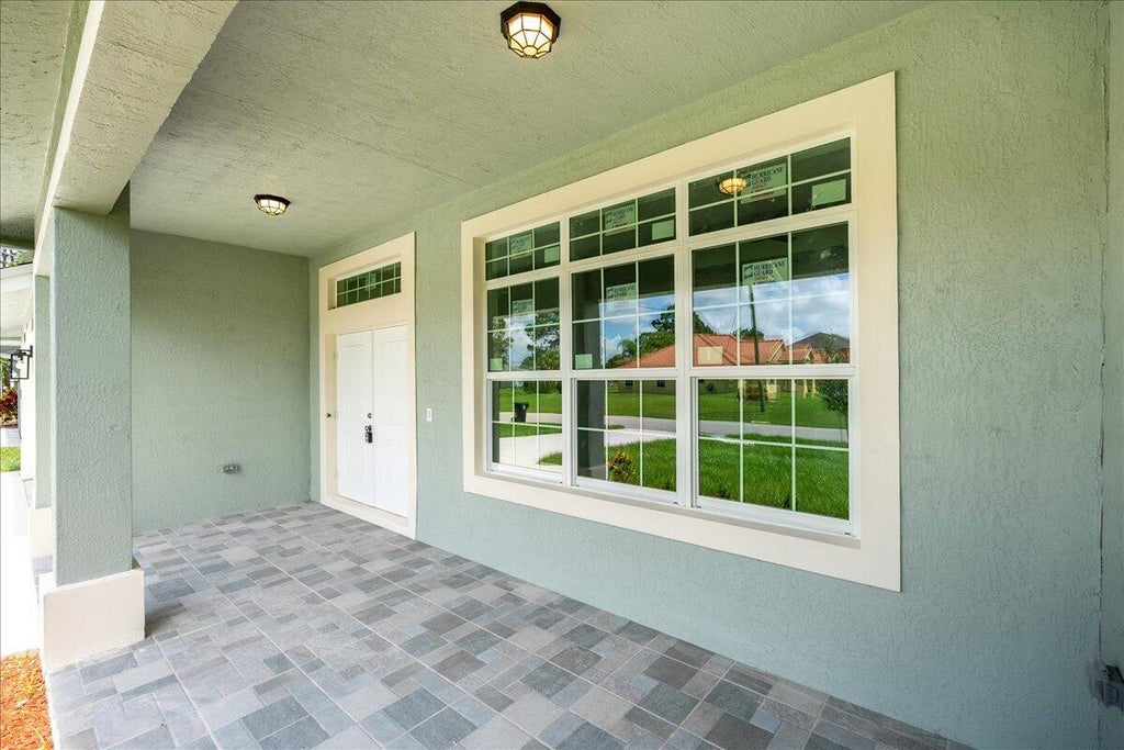 Photo of 1281 SW Ingrassina Avenue, Port Saint Lucie, FL 34953 (MLS # R10999091)