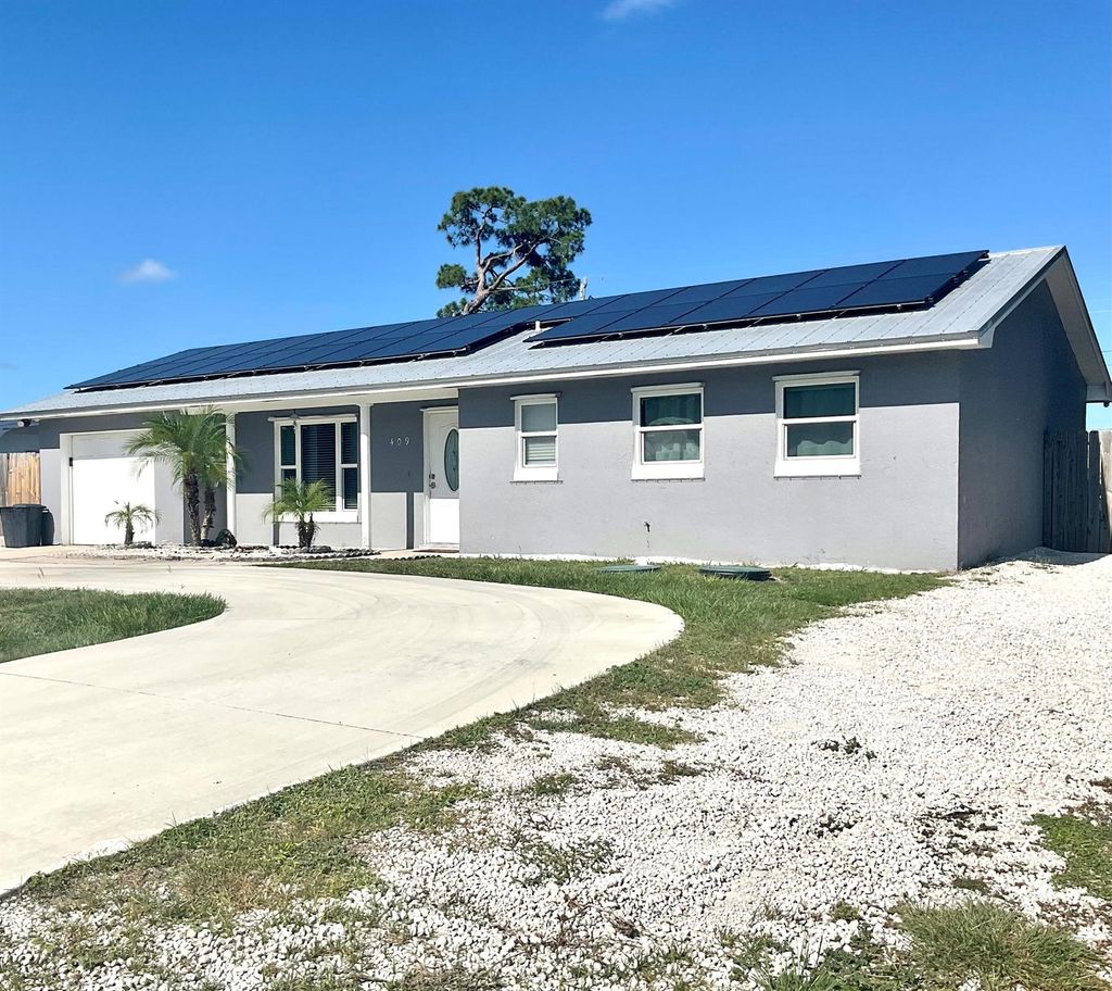 Photo of 409 NE Oleander Avenue, Port Saint Lucie, FL 34952 (MLS # R11100931)