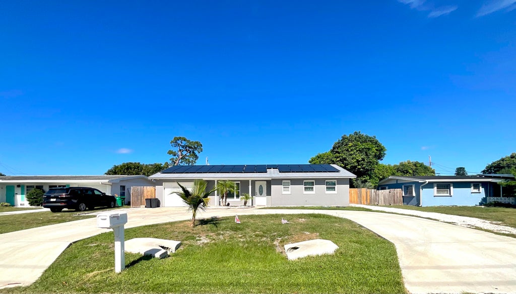 Photo of 409 NE Oleander Avenue, Port Saint Lucie, FL 34952 (MLS # R11100931)
