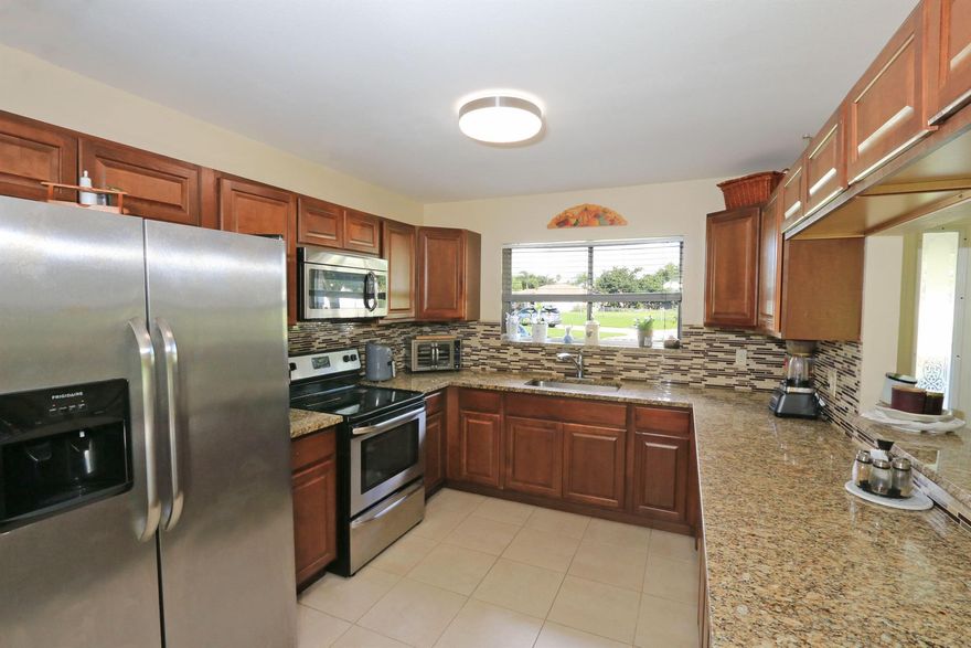 Charming 3BR/2BA home in central Port St. Lucie! Features an updated kitchen with granite countertops, tiled backsplash, stainless steel appliances, and ample cabinetry. Enjoy ceramic tile and laminate flooring, a formal dining area with impact sliders leading to a covered lanai. The spacious 17,526 sq ft lot offers a large backyard with a shed, room for a pool, and space to park your RV or boat. Parks Edge POA includes clubhouse, pool, tennis & shuffleboard for just $18.71/month! Close to schools, shopping, dining, and Mets Spring Training. Only 45 mins to Palm Beach Airport. Enjoy the beautiful beaches, fishing, and boating of the Treasure Coast!