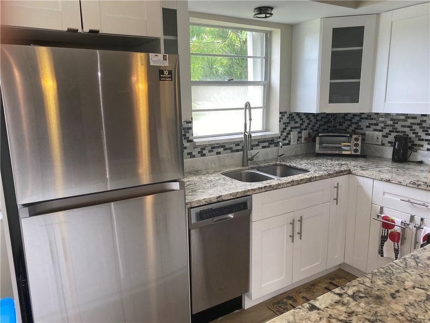 FIRST FLOOR CORNER HOME CLOSE TO THE EAST GATE OF CENTURY VILLAGE. BEAUTIFULLY LICENSED REMODELED CONDO....OPEN KITCHEN WITH WHITE CABINETRY, STAINLESS STEEL APPLIANCES, GRANITE COUNTERS, RECESSED AND PENDANT LIGHTING, WATER FILTRATION SYSTEM. CHARMING LARGE WOOD PLANK CERAMIC TILE FLOORING THROUGHOUT.  BOTH BATHROOMS HAVE BEEN COMPLETELY REMODELED WITH ELEGANT TILE AND A SPA FEATURE IN THE SHOWER/BATH COMBO.  NEWER ELECTRICAL PANEL, RECESSED LED DIIMING LIGHTING, ACCORDION STYLE STORM SHUTTERS ON ALL WINDOWS AND PATIO....THIS ONE HAS IT ALL! ASSOCIATION CLAIMS 55+ CENTURY VILLAGE HAS A LARGE ARRAY OF AMENTIES INCLUDING AN INDOOR POOL, THEATER, FITNESS CENTER, BILLIARDS, PICKELBALL, TENNIS AND SO MUCH MORE!