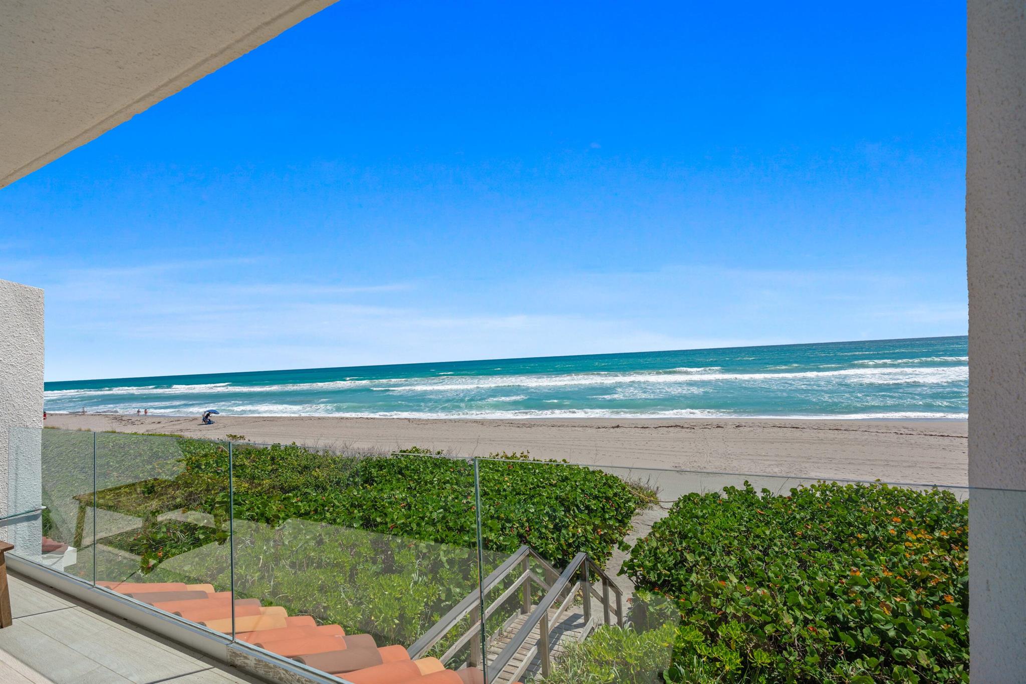 RARELY AVAILABLE - DIRECTLY ON THE SAND!Experience ultimate beachfront living in this stunning multi-level townhome with sweeping Atlantic views from every level! The luminous first floor features a chic living area with a wet bar and a versatile office/den. The open middle level boasts a gourmet kitchen with spacious dining and living areas that open to an expansive balcony. Ascend to the top-floor primary suite with dual vanities and refined finishes. Enjoy exclusive beach access just steps from your back door! Upgrades include a brand new roof (May 2024), a Trane A/C under 2 years old, a private outdoor shower, large oceanfront balconies w/impact seamless glass railings and hurricane-resistant windows. Fully furnished and ready for you to embrace coastal luxury!