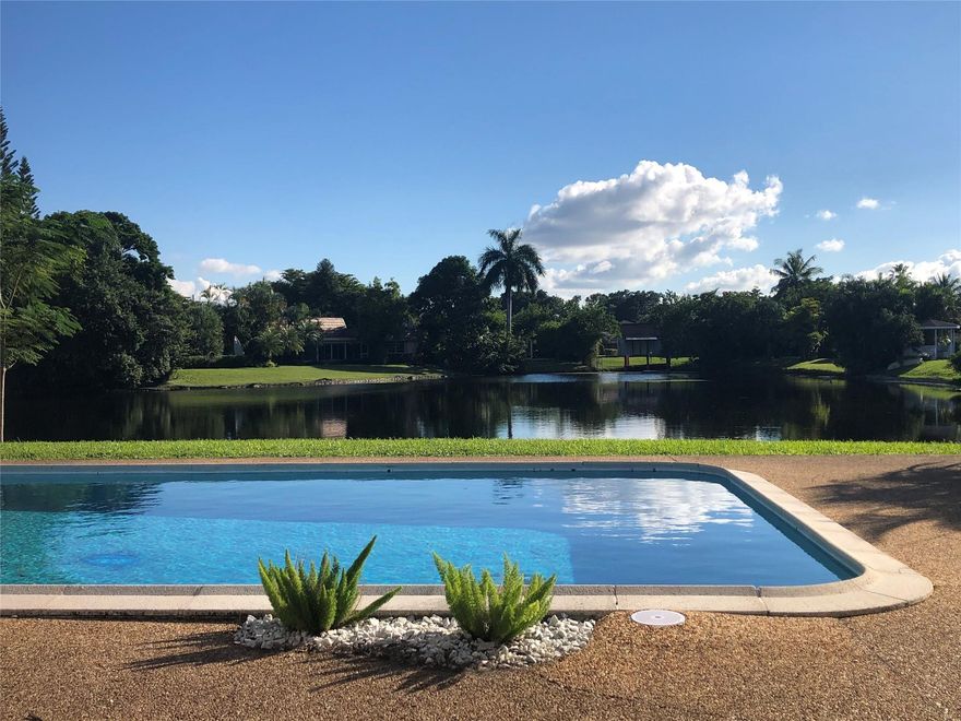 WAKE UP TO A SPECTACULAR VIEW OF THE LAKE IN A 4 BEDROOM, 3 BATH SINGLE STORY HOME LOCATED IN JACARANDA COUNTRY CLUB, A GOLFER'S PARADISE.  NO MANDATORY GOLF MEMBERSHIP.  ANNUAL HOA IS UNDER $500/YEAR.  OPEN FLOOR PLAN, 2 CAR GARAGE WITH A 2021 INSTALLED HURRICANE RATED DOOR, LARGE CIRCULAR DRIVEWAY, GATED BACKYARD WITH A FABULOUS POOL (DIAMOND BRITE AND TILED IN 2021) TWO 5 TON AC UNITS (REPLACED IN 2021) NEW KITCHEN CABINETS AND COUNTERS (JAN 2024), TWO WATER HEATERS REPLACED 2021.  HURRICANE RATED 10' SLIDING DOORS AND KITCHEN WINDOWS OVERLOOKING THE LAKE (2021).  WATERPROOF VINYL THROUGHOUT (INSTALLED IN 2021-2023)