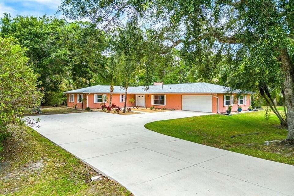 Experience Florida living in beautiful Vero Beach! This spacious 4-bedroom, 3-bathroom home offers 2,628 square feet of living space on a half-acre corner lot with no HOA restrictions--bring your boat or RV. Featuring a 2-car garage and large driveway, this property offers plenty of space for everyday living and entertaining. The fully fenced backyard is a private retreat with mature landscaping, a koi pond, playground, storage shed, and a covered lanai perfect for relaxing or hosting guests. Inside, enjoy a flexible bonus room ideal for a guest suite, office, or gym. Conveniently located close to restaurants, shopping, and dining, with Vero Beach's beautiful beaches just minutes away and easy access to I-95 and the Turnpike.