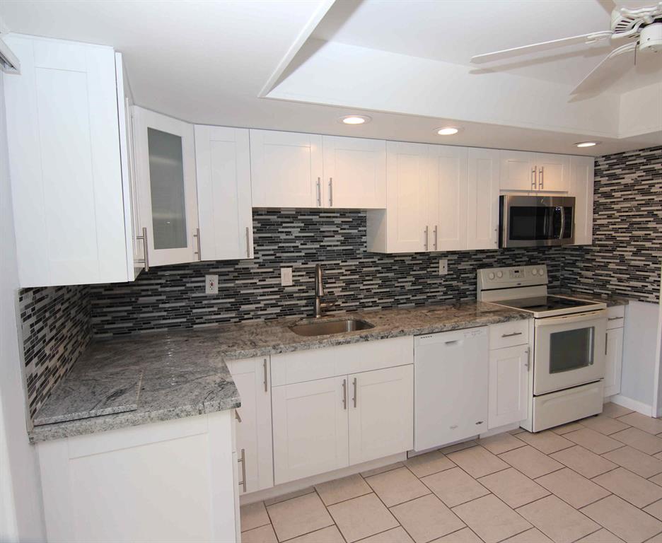 Immaculate EAST BOCA Duplex in area of expensive homes! Gorgeous GOURMET KITCHEN w/high end finishes including white wood Shaker cabinets, GRANITE counter tops and sizzling GLASS MOSAIC back splash. Two nice-sized bedrooms + TWO TOTALLY REMODELED BATHS with beautiful tile & wood vanities. Check out photos. Screened-in 13x10 porch + patio, BIG fenced yard, washer/dryer, hurricane shutters. Small pet under 20 lbs OK. Quiet location on side street w/friendly neighbors. Close to beach, Downtown Boca & Downtown Delray. See it today and move in tomorrow. Local landlord looking for long term tenant.