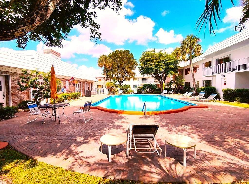 Beautiful bright & airy 2-bed, 1.5-bath corner condo & truly feels like home the moment you walk in. Brand new roof, brand new A/C, & recently updated floors baths & kitchen. Furniture can be included. One of the most unique listings available. This 2nd floor sunlit gem is filled w/natural light & charm, features wood floors, modern kitchen S/S appliances & designer baths w/ thoughtful touches. Step inside & appreciate the warmth & style. Located in the heart of Pompano Beach, minutes to pristine beaches, vibrant new fishing pier, oceanfront dining, boutique shopping, I-95 & endless outdoor fun—from water taxis to family-friendly parks & fitness trails. It feels like you're on vacation every day w/ resort-style amenities: sparkling pool, clubhouse, shuffleboard & lively community events.