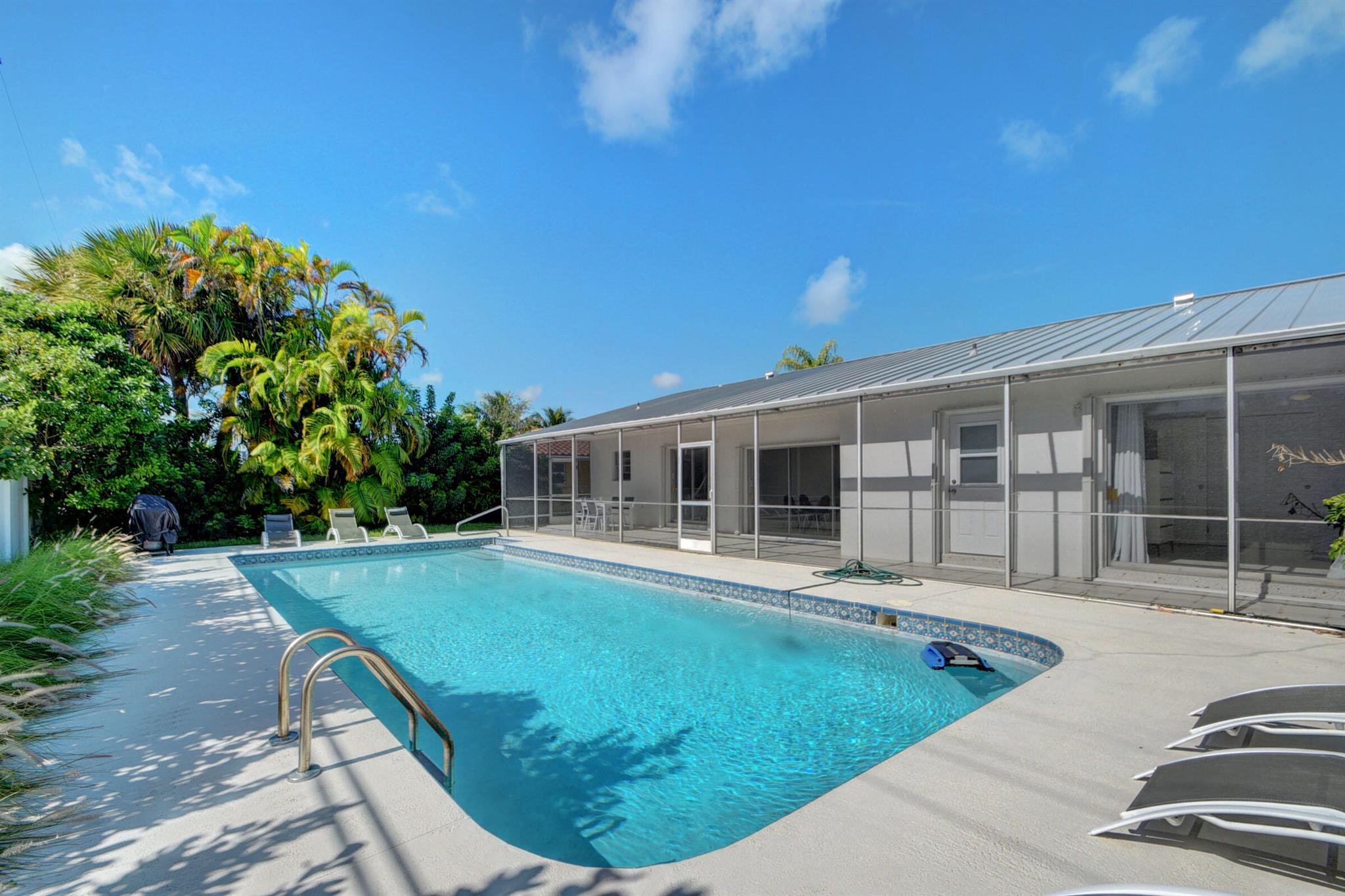Annual Rental, Will consider Short-Term Rental, WALK TO THE BEACH! 4-Bdrm. 2-Bath. 2-Car Garage. Located in Desirable ''Palm Beach Isles'' on exclusive SINGER ISLAND. Open Living Area. Kitchen w/views of Beautiful Private Fenced Backyard and 15x40 Pool. Master Bdrm and Living Area w/Sliding Glass Doors to Screened Patio and Open Pool area. Kitchen w/pass thru window to Patio. Terrazzo Floors throughout. Path to Beach at end of street! Walking distance to Shops, Marinas, Restaurants. 20-mins. to Palm Beach Island, PBI Airport and CityPlace. Short drive to Palm Beach Gardens and Jupiter / Juno.