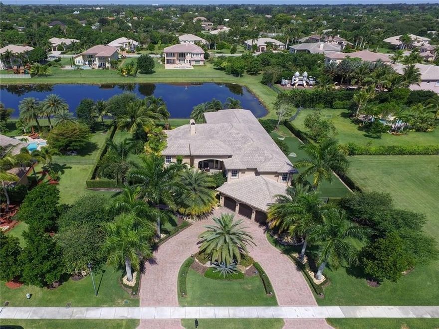 Discover the luxury&prestige of owning your own custom Renoir Majestic w/6680sqft under air,&8570 total sqft.6/7 quadruple split floor plan sitting on a fabulous waterfront builder’s acre w/tropical pool area&summer kitchen.Marble flooring,wood burning fireplace,enormous loft,&guest suite.Expansive Master wing w/sitting area,&over-sized customized closets.Gourmet kitchen,wet bar,wine rack,&many high end appointments throughout.Accordion shutters,extended pavered circular driveway&professionally decorated.