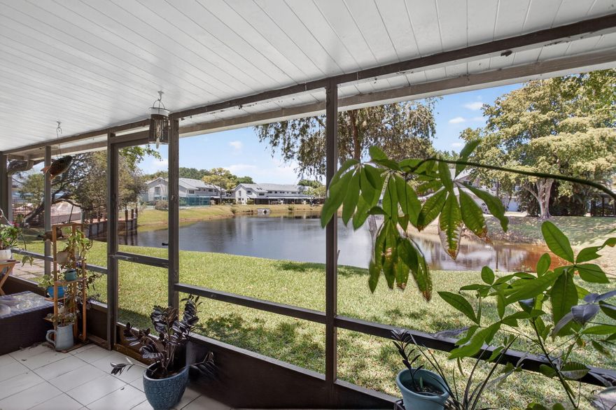 Rarely available 2/2 corner villa with one car garage in popular Discovery Pointe, an all ages, investor friendly, gated community just 6 miles to the beach! Enjoy serene lake views from your private, screened porch. Inside you will find a great flow, vaulted ceilings, luxury vinyl floors in the living/dining area, crown molding, an interior laundry, and a split bedroom floor plan. The kitchen features an eat in area, a skylight bringing in natural light, and a newer refrigerator, disposal, and dishwasher. The spacious primary suite includes a walk-in closet and an en suite bath with sliders to a small private patio. In addition to the one car garage, there are two parking spaces that convey with the villa allowing plenty of parking for you and your guests. Enjoy worry free living with a   2025 Roof and A/C and a low HOA fee that includes lawn care and roof maintenance. The villa is close to the clubhouse which includes a fitness center, pool, spa, sauna, tennis, basketball, and racquetball courts, a picnic area, a BBQ area, a playground, and a waterfront pier. One pet under 40 pounds is welcome and there is no waiting period to lease. Schedule a private showing and start living the South Florida lifestyle.