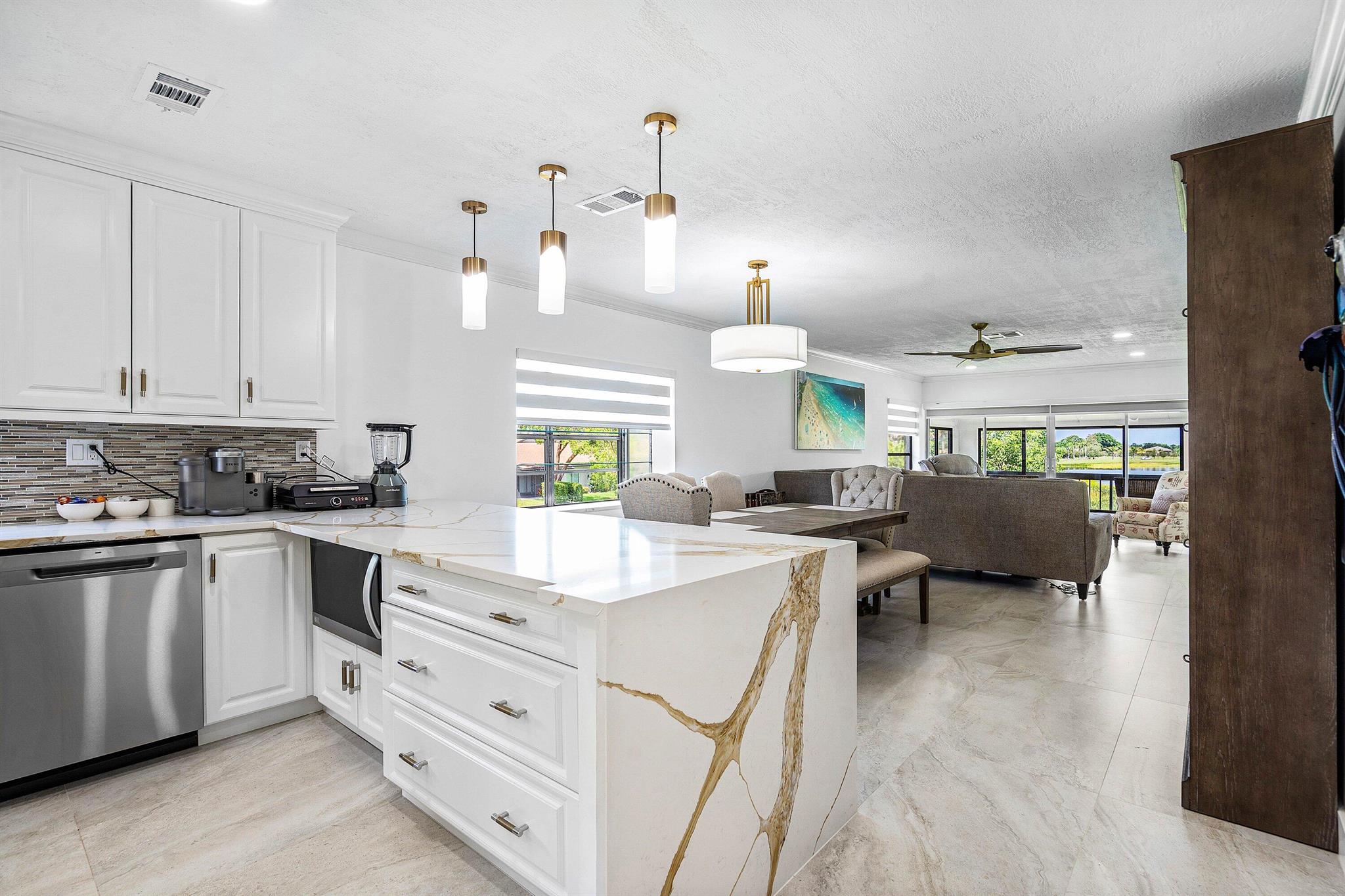 Fully furnished and turnkey, this beautifully remodeled 2BD/2BA condo in Palm Greens of Delray Beach is a true showpiece. Spanning 1,381 sq ft, it offers a light-filled open layout with breathtaking lake views from the living room and oversized screened balcony. Features include brand-new LG appliances, 2023 AC with new ductwork, custom primary closet, shiplap walls, new tile flooring, crown molding, white shaker cabinets, pull-out pantry, and solid roll-down shades. Palm Greens is unveiling a new 30,000 sq ft clubhouse with resort pools, tennis, pickleball, gyms, cafe, and more plus scenic walking paths and enhanced landscaping. Ideally located near beaches, shopping, dining, and highways, this home blends modern style, convenience, and resort-style living.