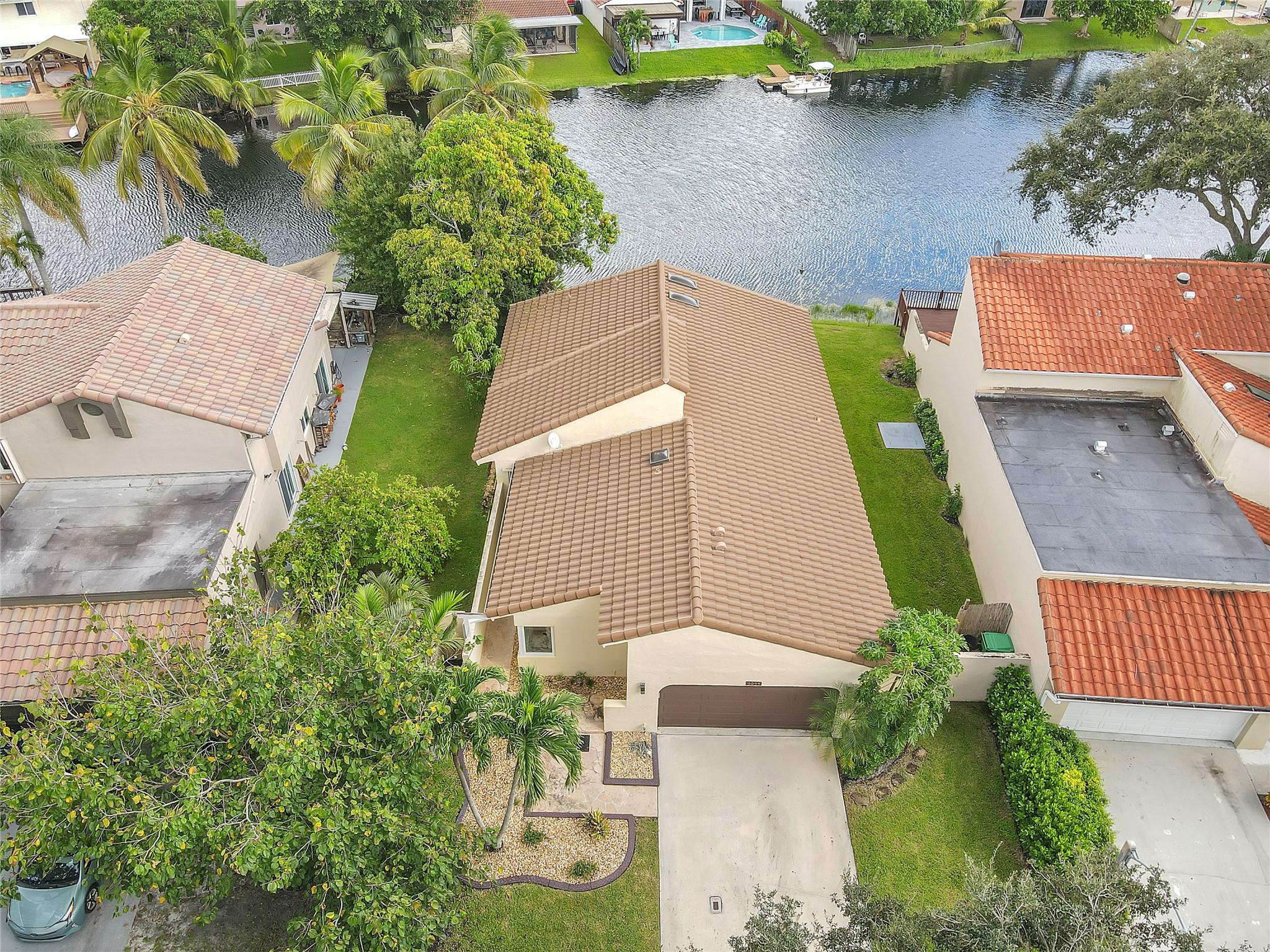 WELCOME to Cooper City. This Magnificent Lakefront Home on a cul-de-sac road in the heart of Rock Creek community. This upscale oasis offers a touch of luxury with its upgraded interiors and stunning lake view. Step inside to a bright, open floor plan wood plank title floors, 3-way split plan, Gorgeous upgraded kitchen featuring granite countertops and high-quality stainless-steel appliances. Every corner of this home screams elegance with comfort. Covered patio for movie nights or a tranquil morning coffee. Included is hurricane impact windows for ultimate protection. Situated in a welcoming community for a nominal fee you can enjoy access to the recreation center. 2-car garage with backyard access, A fenced yard overlooking a wide Lakeview to relax & enjoy your weekend w/ family & BBQ.