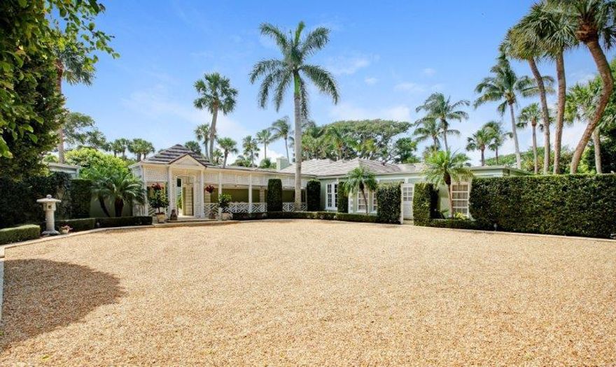 A fabulous indoor swimming pool, spacious 4-bedroom guesthouse, cozy cottage, and private courtyard with swimming pool are among the many highlights of this uniquely designed Jupiter Island estate. Its elevated position captures spectacular vistas of the Intracoastal Waterway and the Hobe Sound National Wildlife Refuge beyond. . The stunning, contemporary style main residence overlooks a breathtaking expanse of green lawns that sweep down to 225+/- feet along Jupiter Island's historic "Ramble", a scenic pathway that runs along the river.

Tall banyan trees and tropical foliage accentuate the natural beauty of this exceptional over 2-acre property on all sides, creating a serenely private sanctuary. Clean-lined, geometrically dramatic contemporary architecture harmonizes effectively with a more traditional, genteel look portrayed throughout the main house's spacious interior. The result is a timeless appeal that is both comfortable and ideal for entertaining. Principal areas open up to the picturesque outdoors that includes an expansive courtyard with large heated swimming pool. Casual elegance defines a bright living room, accented with a fireplace, that offers see-through front and rear views of the property. An adjacent formal dining room provides easy access to the kitchen and loggia.

Secluded his and her master suites are among the home's special features, offering large walk-in closets, luxurious bathrooms, and a private office. A 4-bedroom guesthouse faces the main house across the courtyard swimming pool. Stately columns accent this private retreat that features a kitchen and spacious living area. A 1-bedroom cottage, near the 3-car garage, offers additional space for guests or family members. Cozy and comfortable, this special cottage shows off a charming great room with volume ceiling, a wall of closets, kitchen, and office.

Noteworthy Features:

Approx. 11,187 total sq. feet / Approx. 9,519 a/c sq. feet ï¿¿ Concrete block & stucco construction ï¿¿ 5-bedroom main house ï¿¿ 4-bedroom guesthouse / 1-bedroom cottage ï¿¿ Over 2 acres of lush tropical foliage & mature trees ï¿¿ Indoor 38' x 20' salt-water pool ï¿¿ Outdoor courtyard 40' x 20' heated swimming pool ï¿¿ Recently replaced air-conditioning system ï¿¿ Recently Installed Ludiowicki-brand tiled roof ï¿¿ His and Her master suites ï¿¿ Newly installed plantation shutters ï¿¿ Parquet or marble floors ï¿¿ Tray ceilings & crown moldings ï¿¿ Private patios or terraces ï¿¿ Wet bar and butler's pantry ï¿¿ Staff quarters with private entrance ï¿¿ Large laundry room with appliances & ice maker ï¿¿ Separate driveway for service entrance