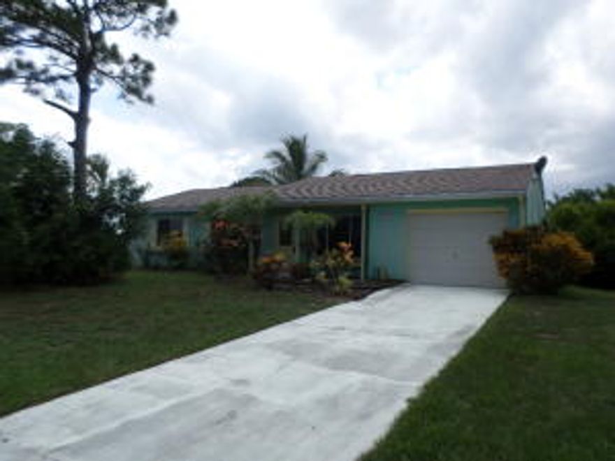 Charming ranch home offers a fully landscaped lot that includes beautiful variations of palms and pine trees scattered throughout the lot!  Step inside to an inviting layout that includes a fully tiled interior, spacious living room, huge kitchen/dining area that opens to open and screened patios in the backyard, and 3 spacious bedrooms.  Terrific community offers a recreational center with basketball courts and pool! Wow, enjoy super easy access to the downtown area, the Turnpike, Treasure Coast High, Windmill Point Elementary, and the St. Lucie River! EQUAL HOUSING OPPORTUNITY. HOA Fees are $250.00 per year.