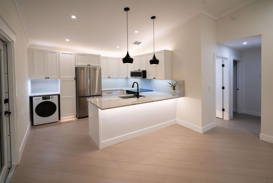 Location Location Location! Nestled at the end of a quite street this home has been fully renovated with luxury designer finishes. It offers a private backyard and 3 parking spaces directly outfront. Only a 5 minute drive to MacAuther Park and Singer Island or Gardens Mall.  Ride a bike to publix and a handful shops and restaurants. Only blocks from the new Ritz Carlton.  This is a fully turnkey home ready to be enjoyed. Perfect for a first time home buyer, be an owner for less than rent! The HOA handles lawncare so it would also make great seasonal home with no maintenance.