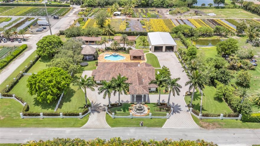 Welcome to this ultra-luxury estate in prestigious Southwest Ranches For Rent or For Sale, set on 2.03 meticulously maintained acres. Fully renovated, this exceptional property is a true masterpiece. The estate includes 8 horse stables & a separate 4,000 sqft garage featuring a private upstairs office with A/C, ideal for conversion into a guest house and another 1,000 sqft garage/storage area. The main residence spans 4,000 sq ft under air and showcases 5 bedrooms, 4 bathrooms, impact windows, a redesigned private gated driveway, and a laundry/utility/mudroom for added functionality. Step outside to your private resort-style oasis, complete with a large pool, Brazilian teak wood ceilings, a summer kitchen, a pool house, and a stunning two story tiki hut with electric and lighting.
