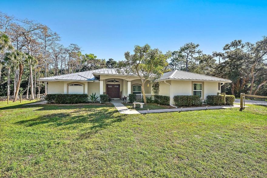 Well-maintained single-family home located in desirable Jupiter Farms. This 4-bedroom, 2.5-bath CBS home built in 2001 sits on 2.5 fully fenced acres with an electronic gated entrance. Features include a 2-car garage, currently used as an office with the garage door still in place and easily convertible back to garage use.

Property offers a newer metal roof approximately 3 years old, full impact windows and doors (2020), and a pool with screened-in patio and partially covered patio. Additional improvements include a brand-new 24 x 35 metal garage/workshop completed in 2025. Large chicken coop on property will remain for new owner,  10 Hens and 1 Rooster can remain if buyer desires.
Spacious lot provides ample room for parking, storage, animals, and outdoor activities. No HOA.